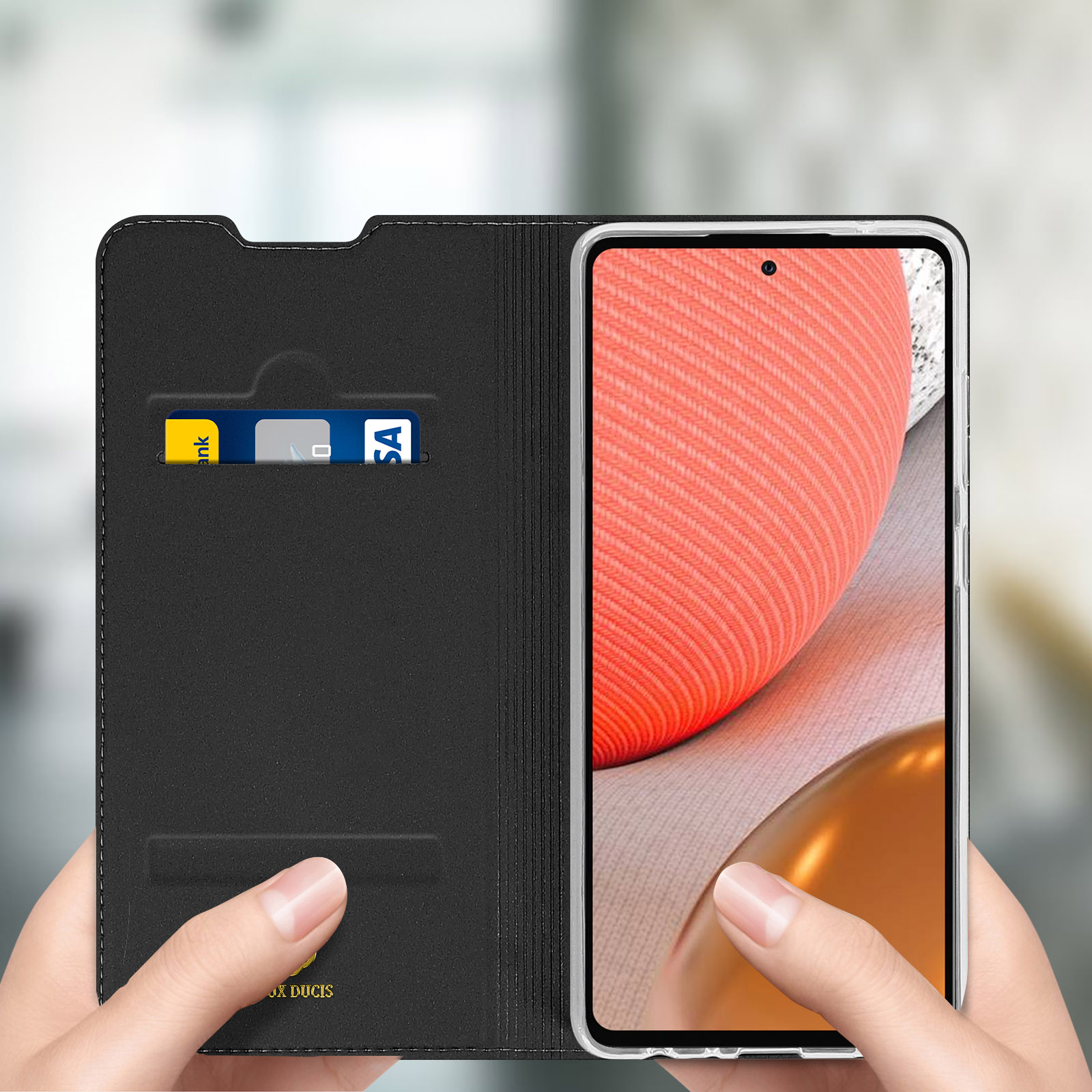 Hand hält Telefon in einer Brieftasche. Kreditkarten und Geld sichtbar.