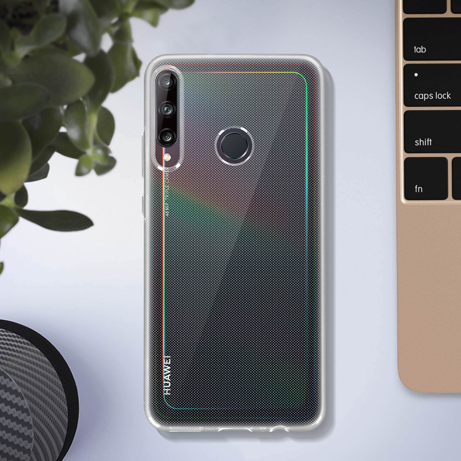 Una custodia per telefono su una scrivania con una tastiera. Ha un logo Huawei e un design a pois colorato.