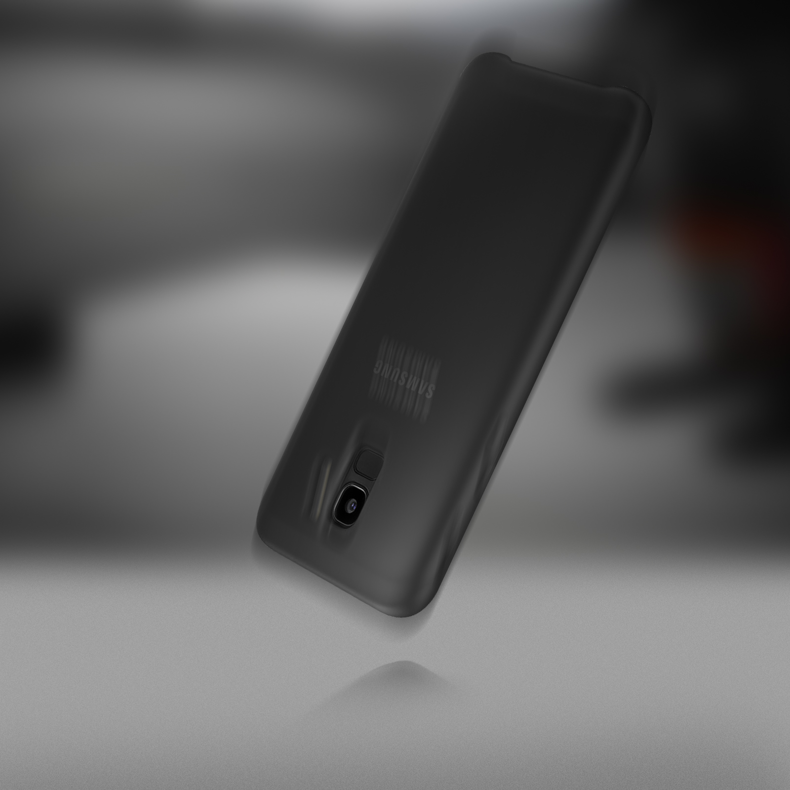 Uno smartphone nero su una superficie grigia. Il telefono ha una fotocamera e un logo Samsung sul retro.
