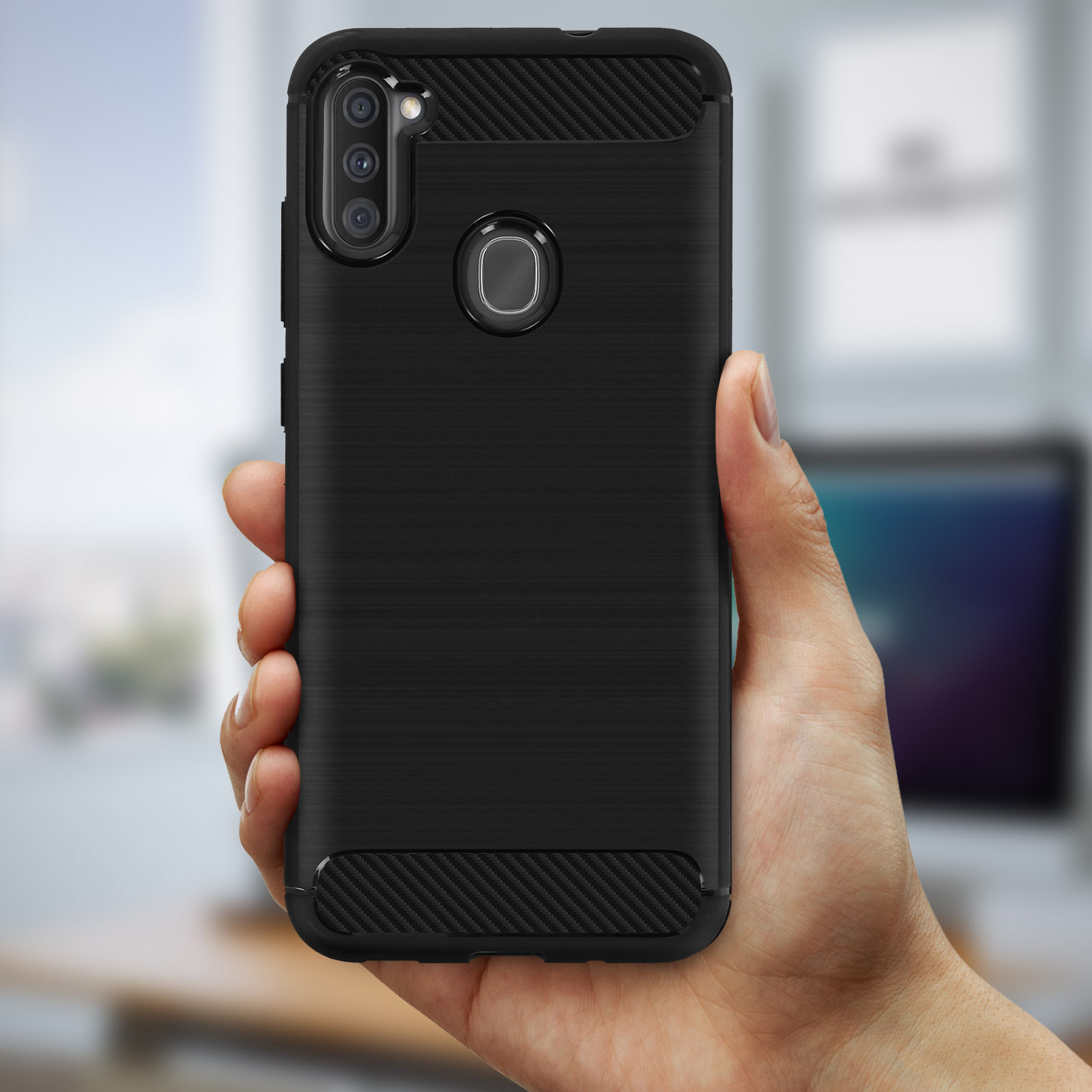 Una custodia per telefono nera con un design in metallo spazzolato. Una mano tiene il telefono.