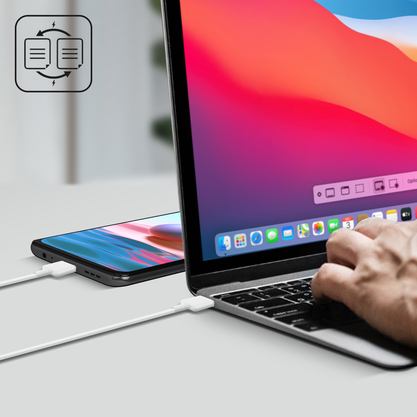 Un telefono e un laptop con un cavo che li collega. Lo schermo del laptop è visibile.