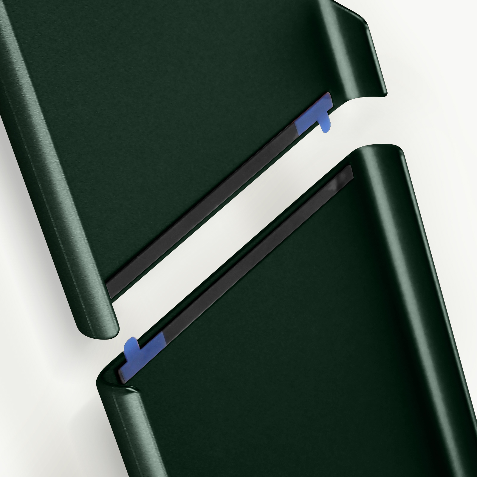 Due pezzi separati di una custodia per telefono verde scuro. La custodia è su uno sfondo bianco.