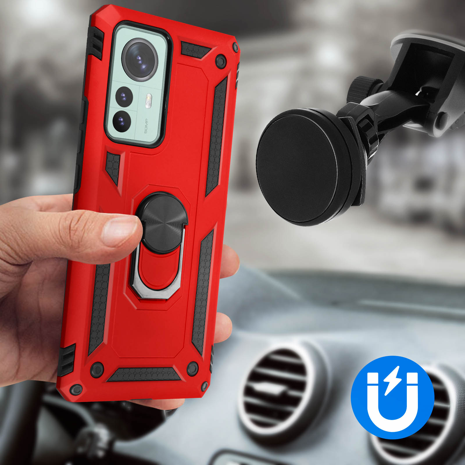 Una mano tiene una custodia rossa con anello e calamita, con un cruscotto di auto sullo sfondo.