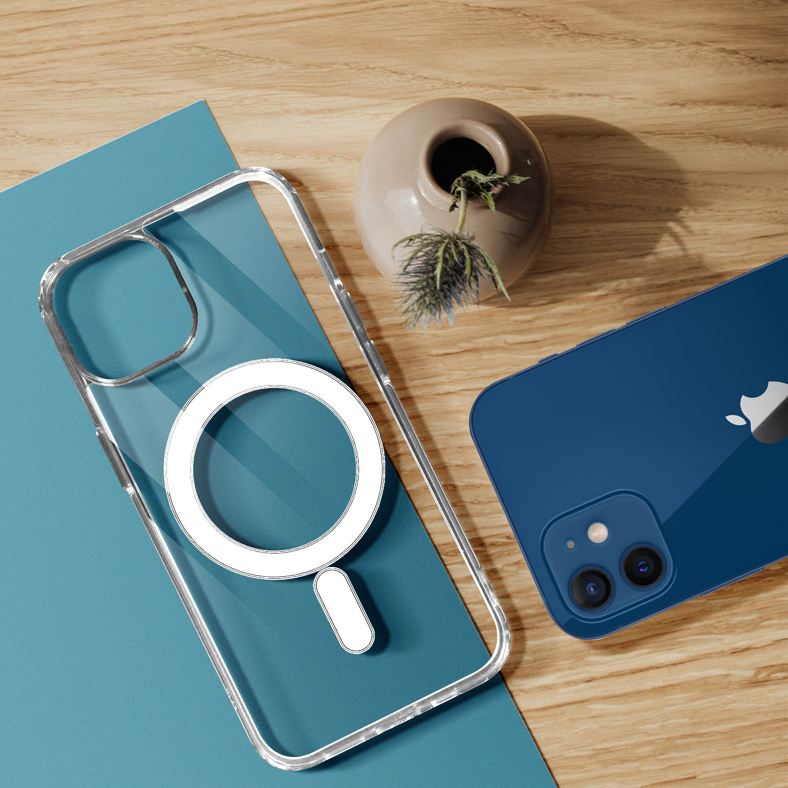 Un telefono e una custodia trasparente con un anello magnetico sono su un tavolo di legno con decorazioni.