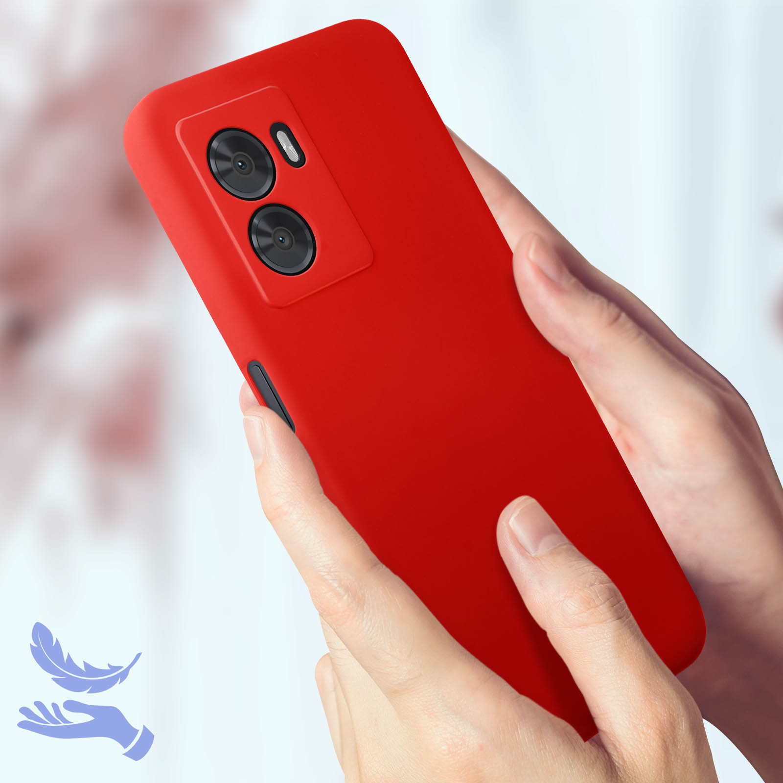 Custodia rossa per telefono tenuta in mano. Due obiettivi della fotocamera visibili. Sfondo sfocato. Simbolo piuma.