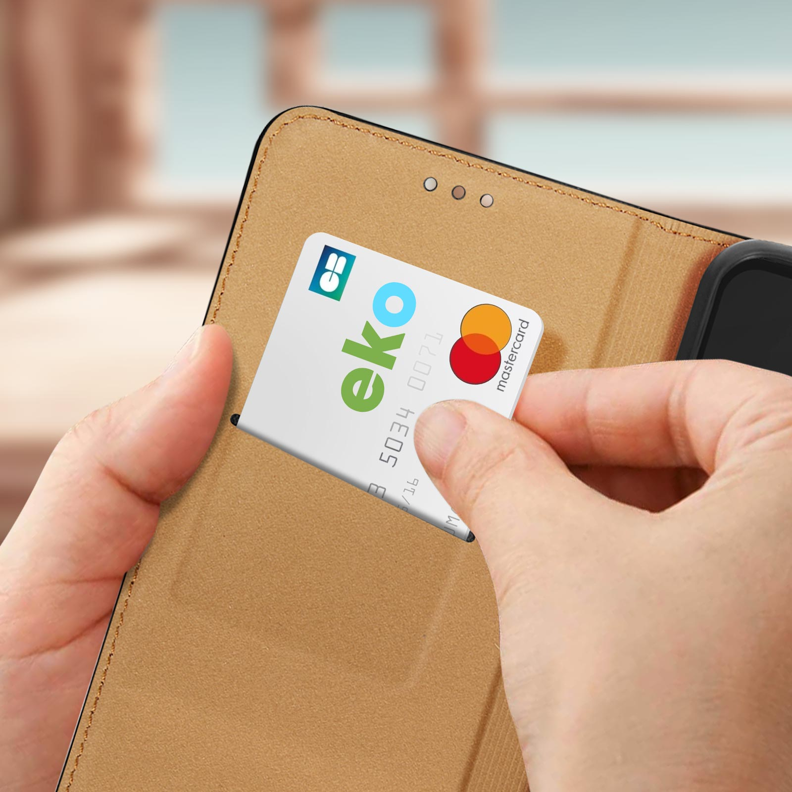 Mano che inserisce una carta di credito in una custodia per telefono con logo Mastercard.