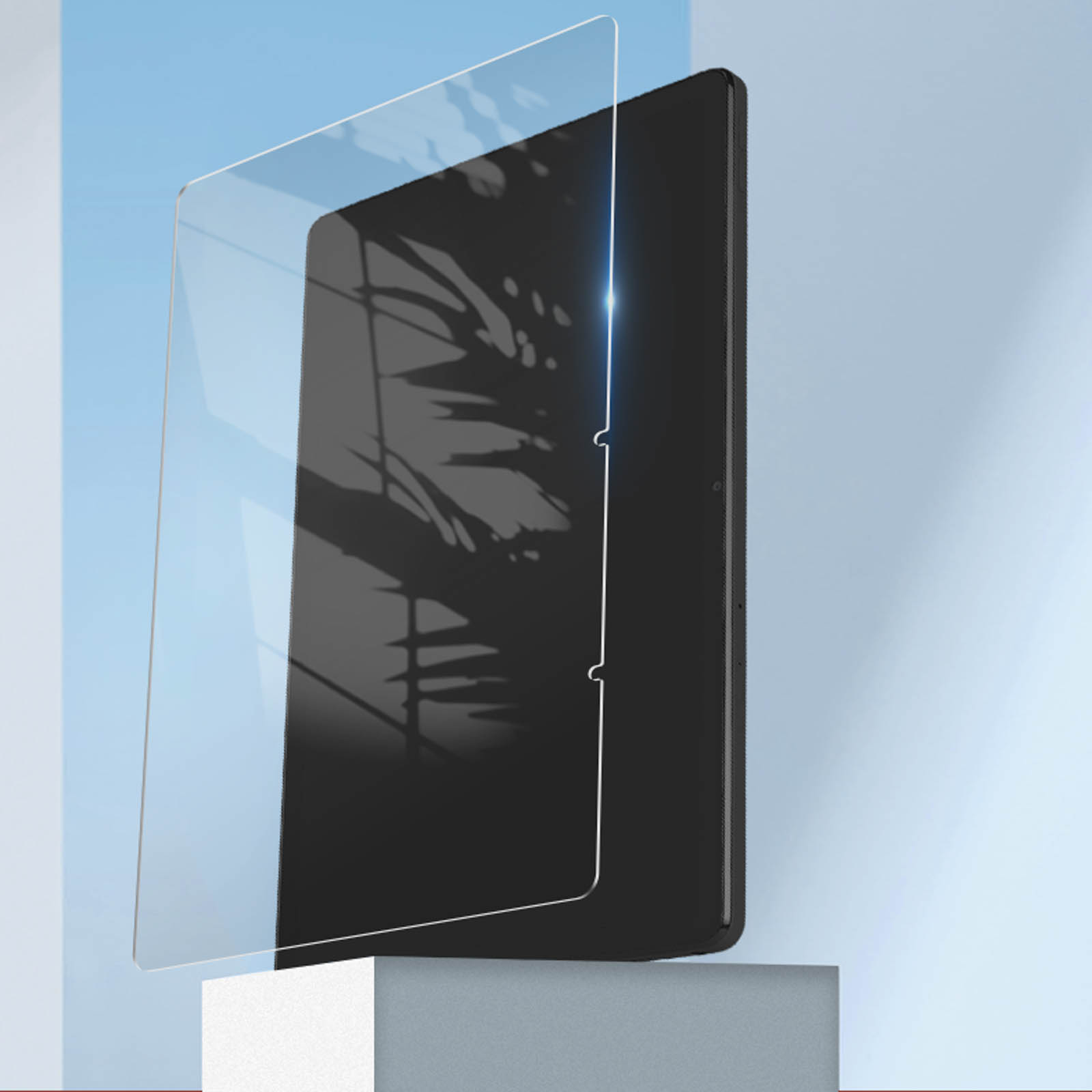 Tableta negra con protector de pantalla. Fondo azul claro con cubo blanco.