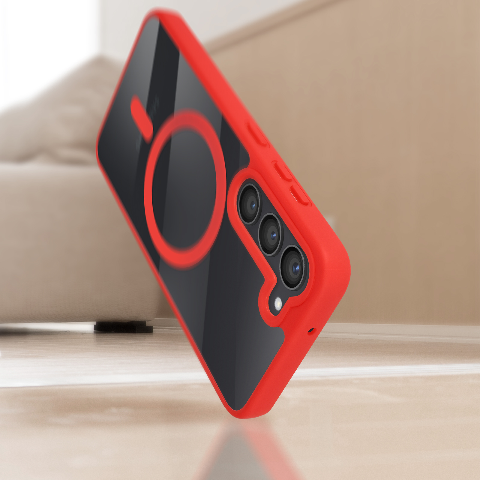 Custodia rossa con retro nero e supporto ad anello su sfondo sfocato. Angolata.