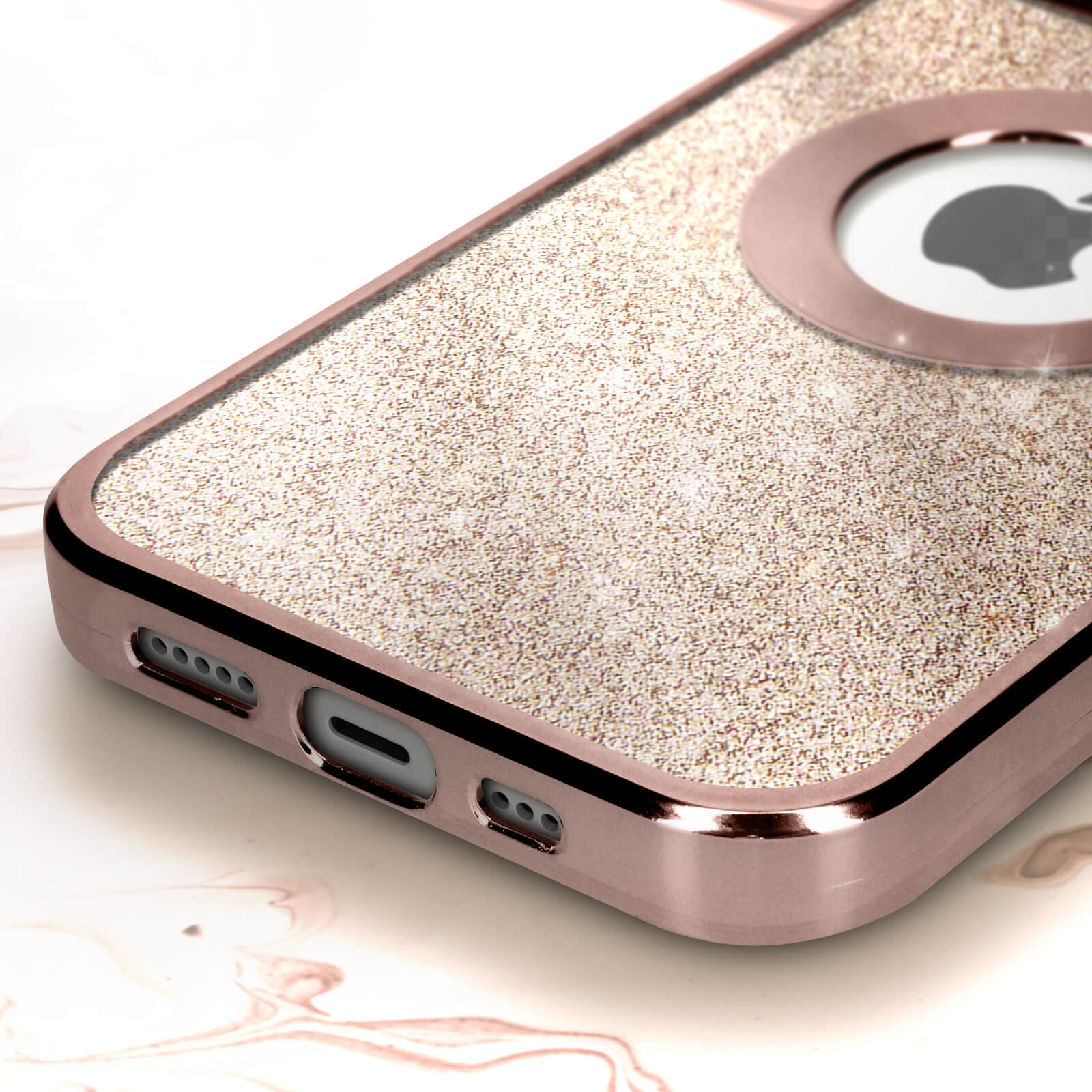Primo piano di una custodia per telefono in oro rosa con superficie glitterata e ritaglio per la fotocamera. Superficie bianca.