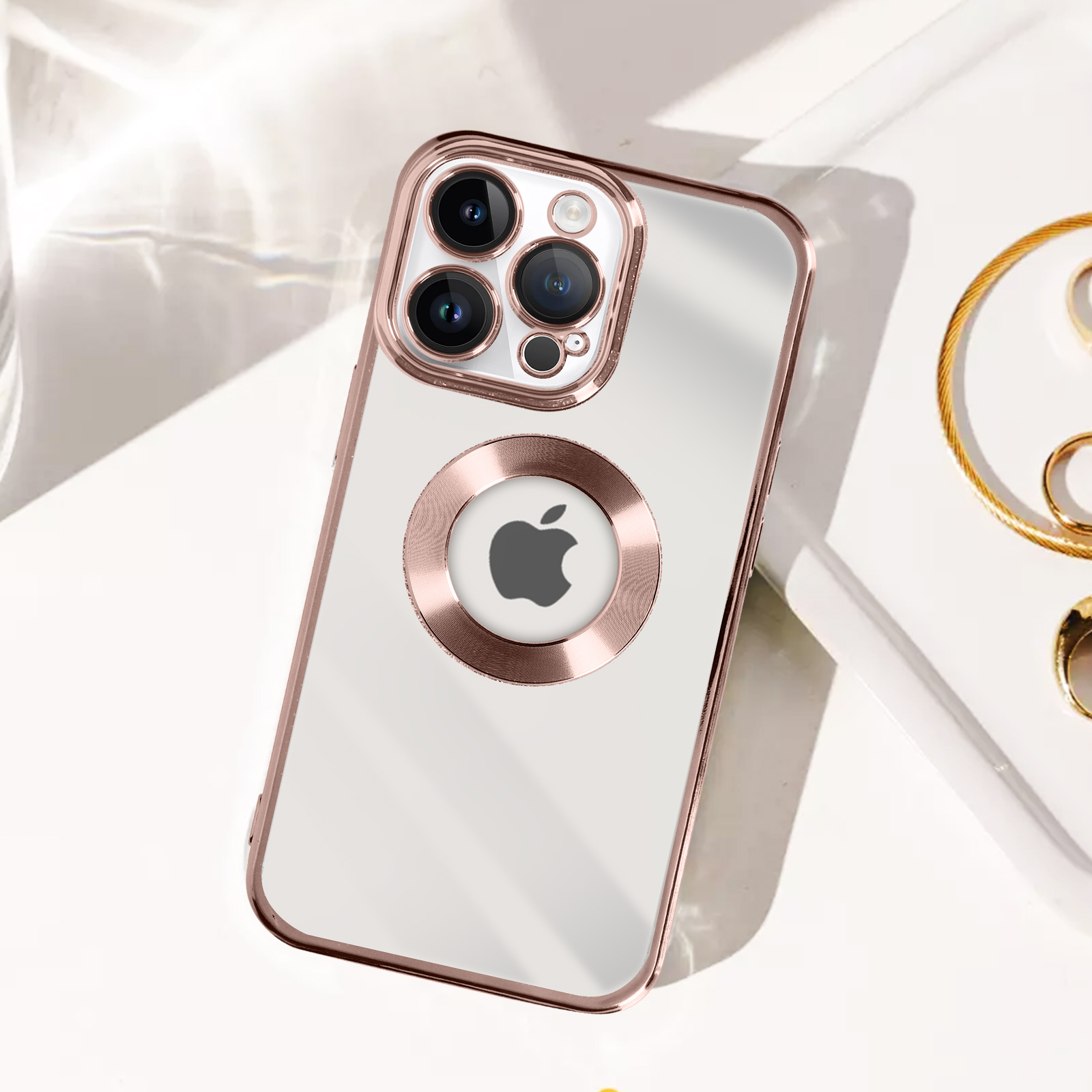 Custodia trasparente con anello e finiture oro rosa. Ha un logo Apple e sfondo bianco.