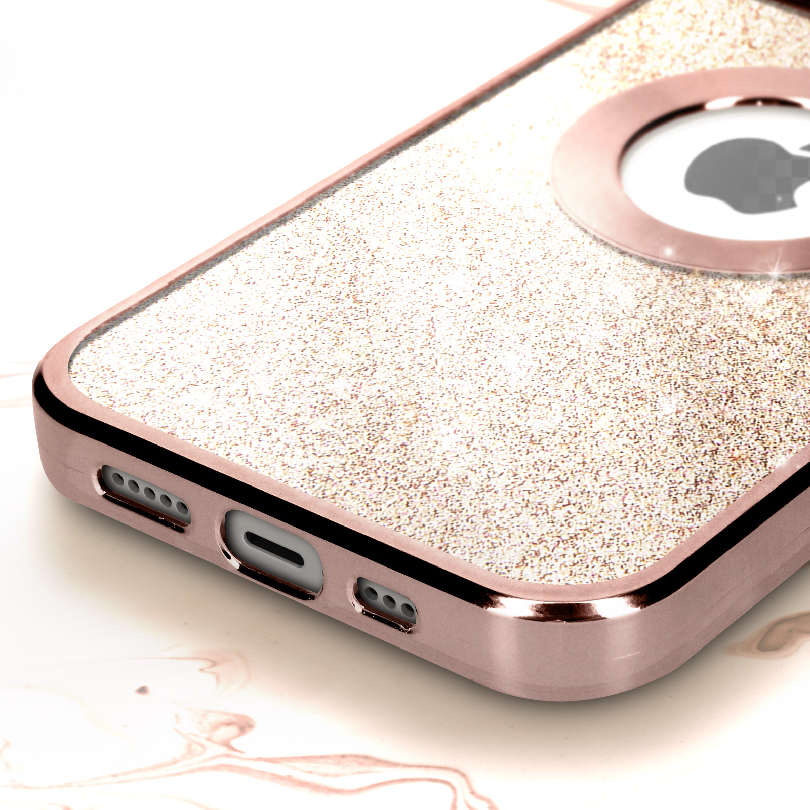 Custodia oro rosa con glitter, primo piano, su superficie bianca.