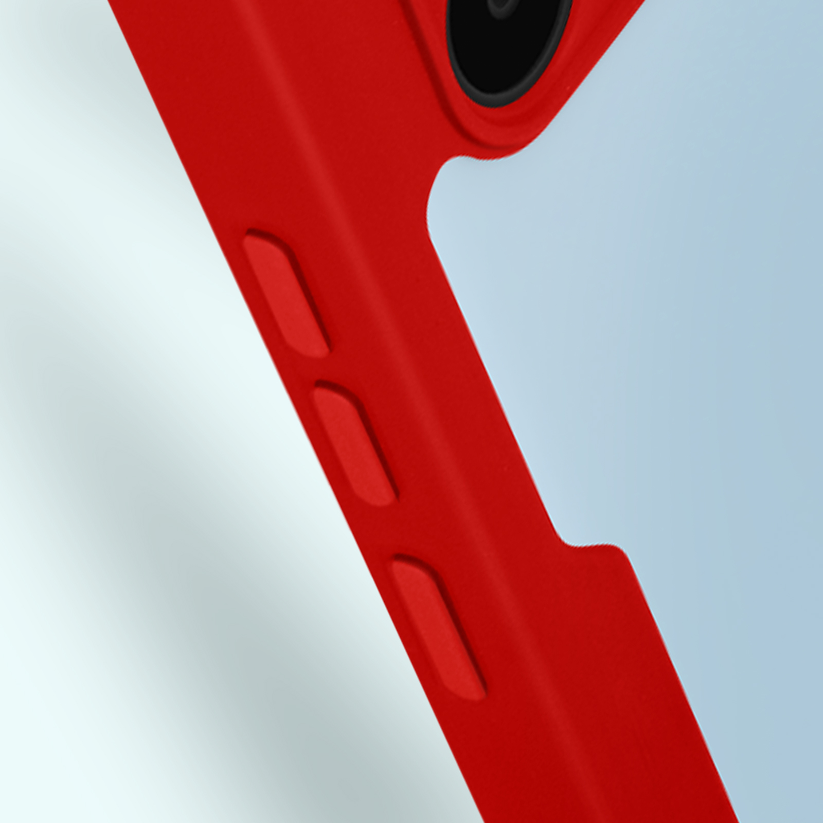 Primo piano di una custodia rossa per telefono con pulsanti e un ritaglio per la fotocamera. Lo sfondo è sfocato.