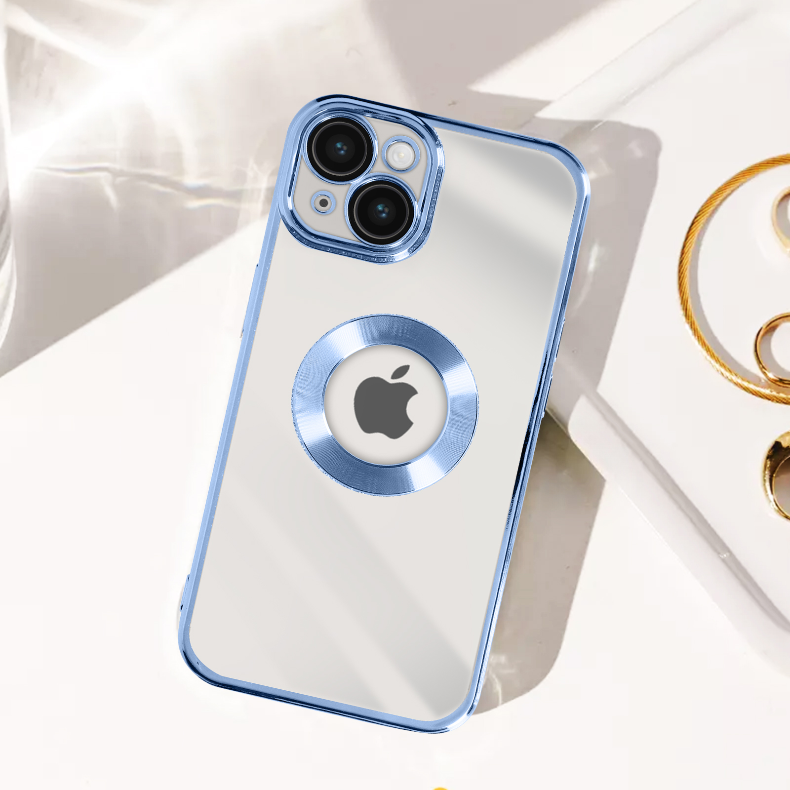 Una custodia per telefono con bordi blu e un porta anello blu. Lo sfondo è bianco con gioielli d'oro.