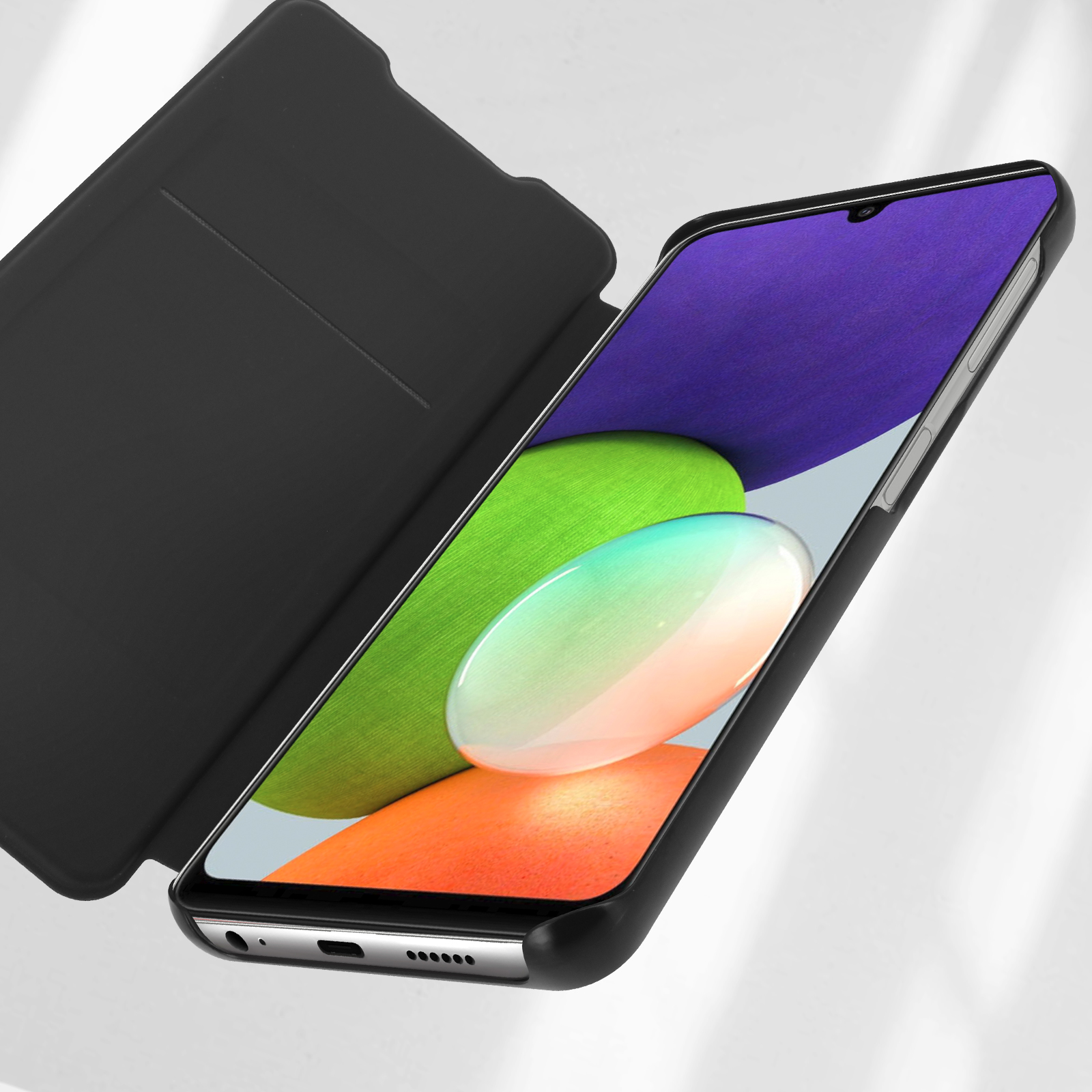 Custodia nera, aperta, con un telefono all'interno. Lo schermo mostra un'immagine colorata.