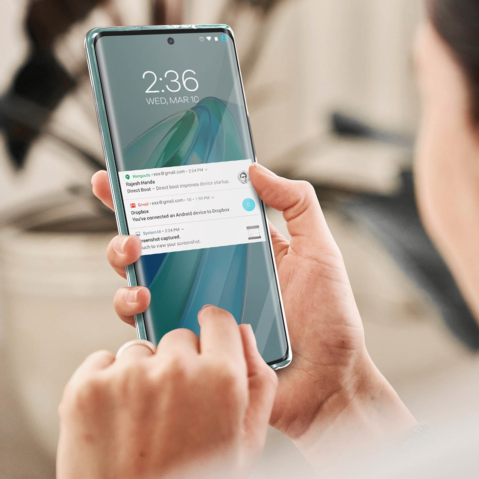 Una mano che tiene un telefono che mostra l'ora e alcune notifiche. È presente uno sfondo azzurro.