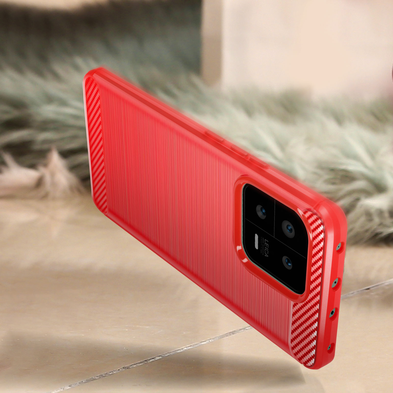 Una custodia per telefono rossa con retro strutturato e lenti della fotocamera.