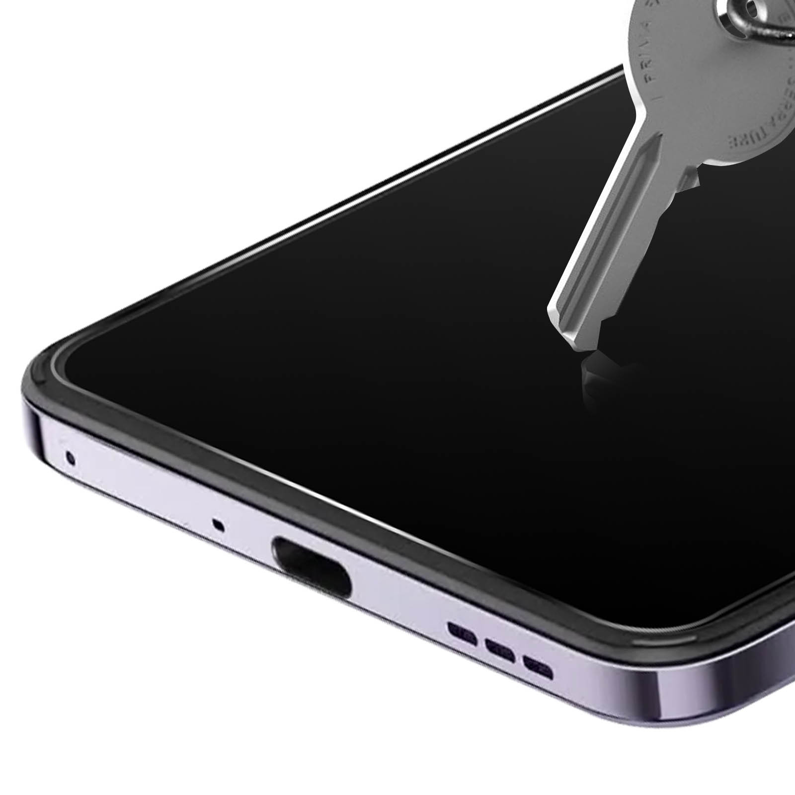 Gros plan sur un écran de téléphone et une clé. Le téléphone a un protecteur d'écran. Le téléphone est argenté.