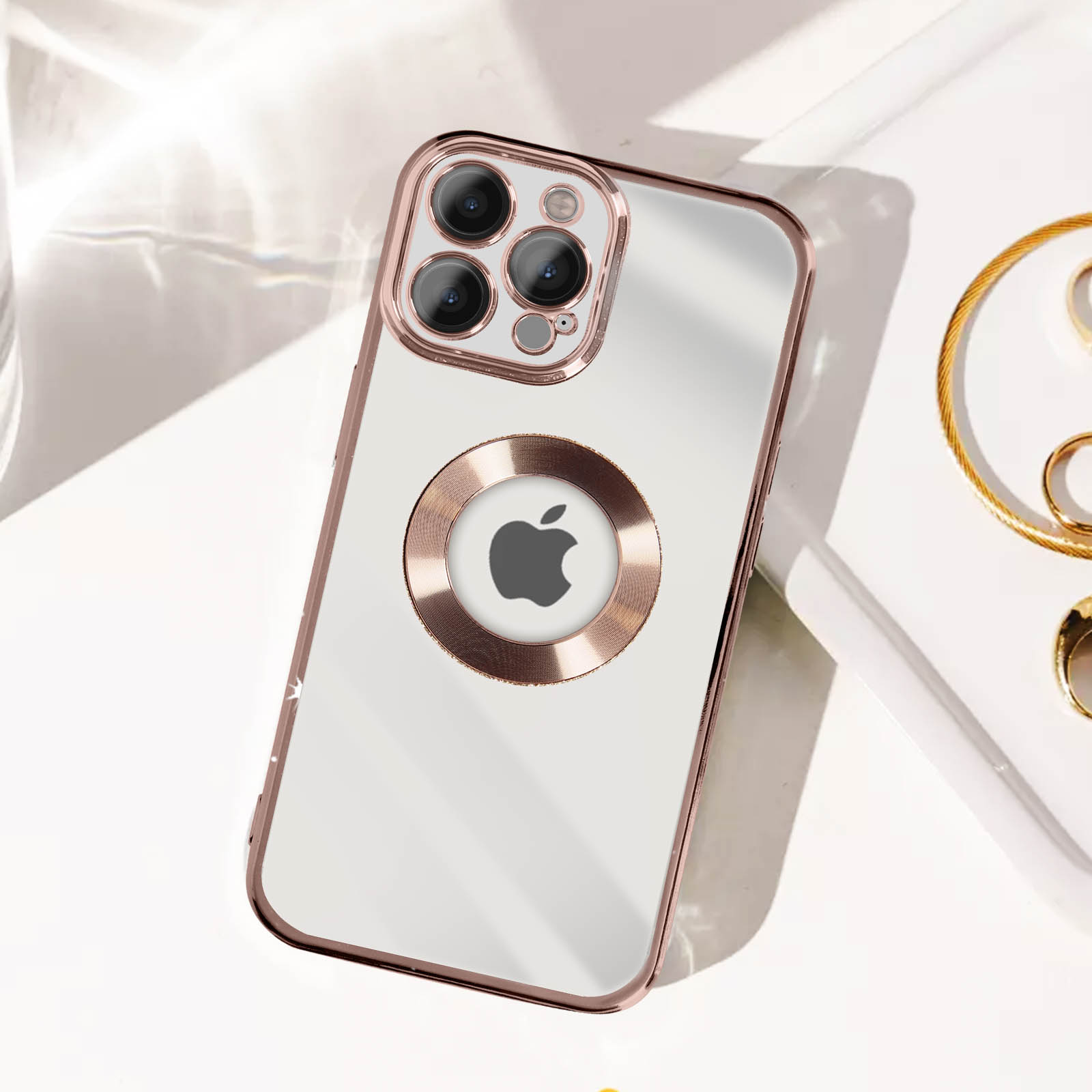 Funda transparente con borde oro rosa y logo Apple.
