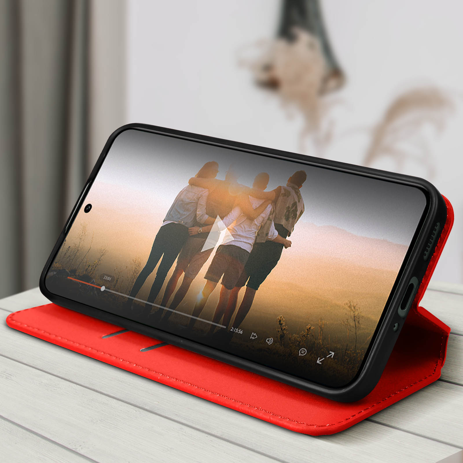 Telefono in una custodia a libro rossa che riproduce un video. La custodia è aperta. Una scena del tramonto è sullo schermo.