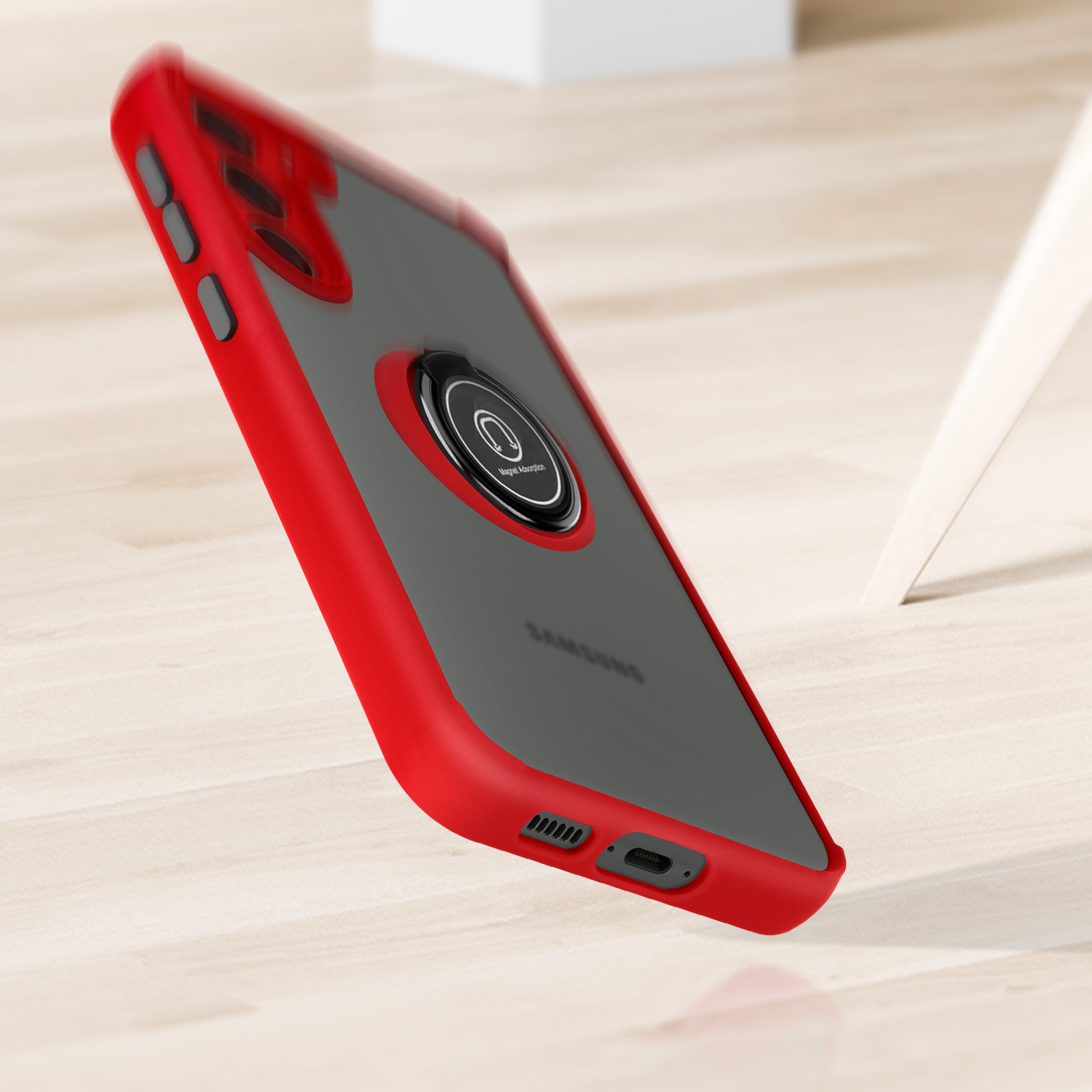 Custodia per telefono rossa con anello di supporto. Il telefono è su una superficie di legno.