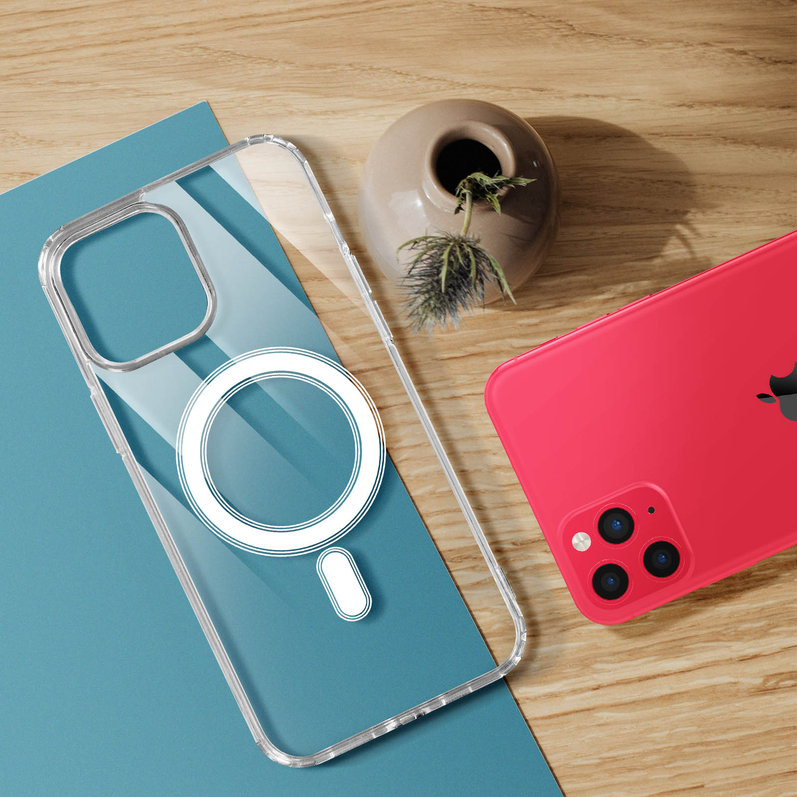 Eine transparente Handyhülle und ein rotes Telefon liegen auf einer Holzoberfläche. Im Hintergrund steht eine kleine Vase.