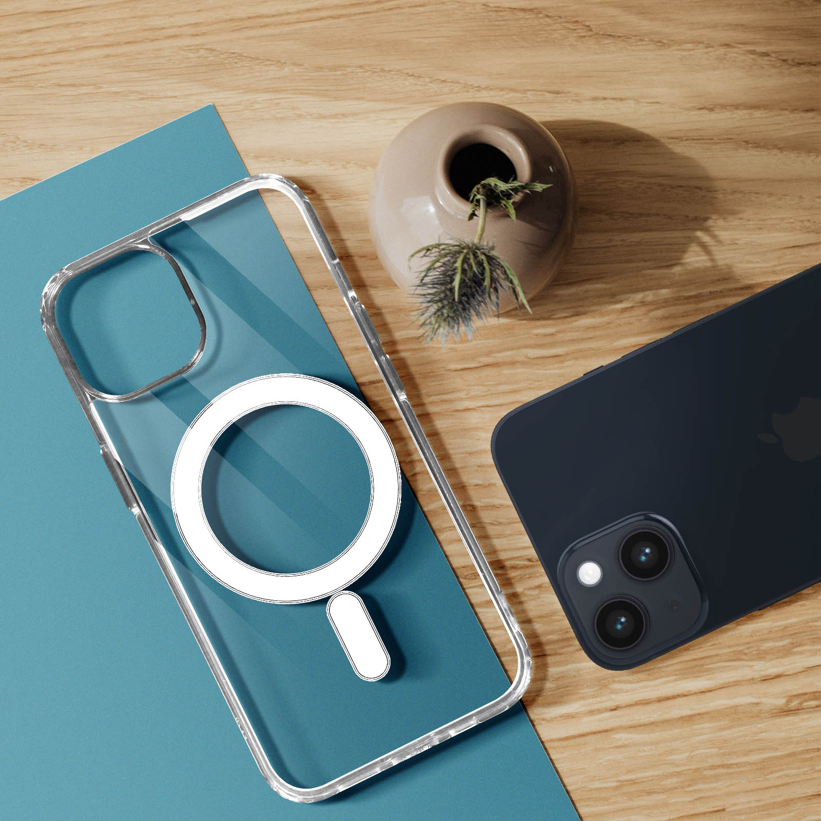 Una custodia trasparente per telefono e un telefono nero. La custodia ha un anello e il telefono poggia su carta blu e una superficie in legno.