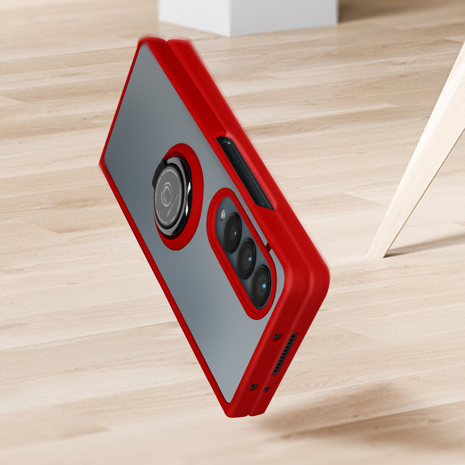 Custodia per telefono rossa e grigia in aria, con pannello posteriore trasparente.