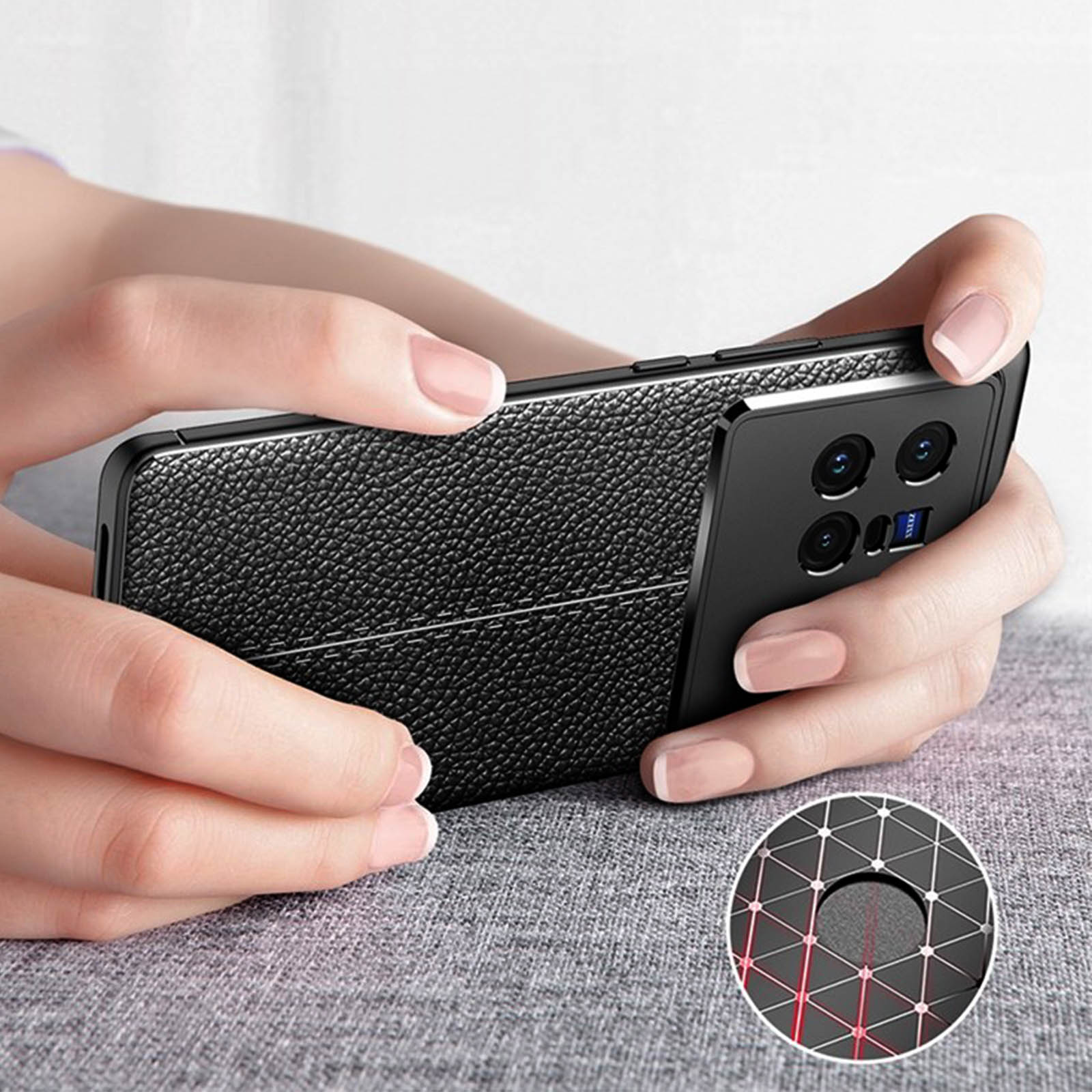 Mani di donna che tengono una custodia per telefono nera con un design strutturato.