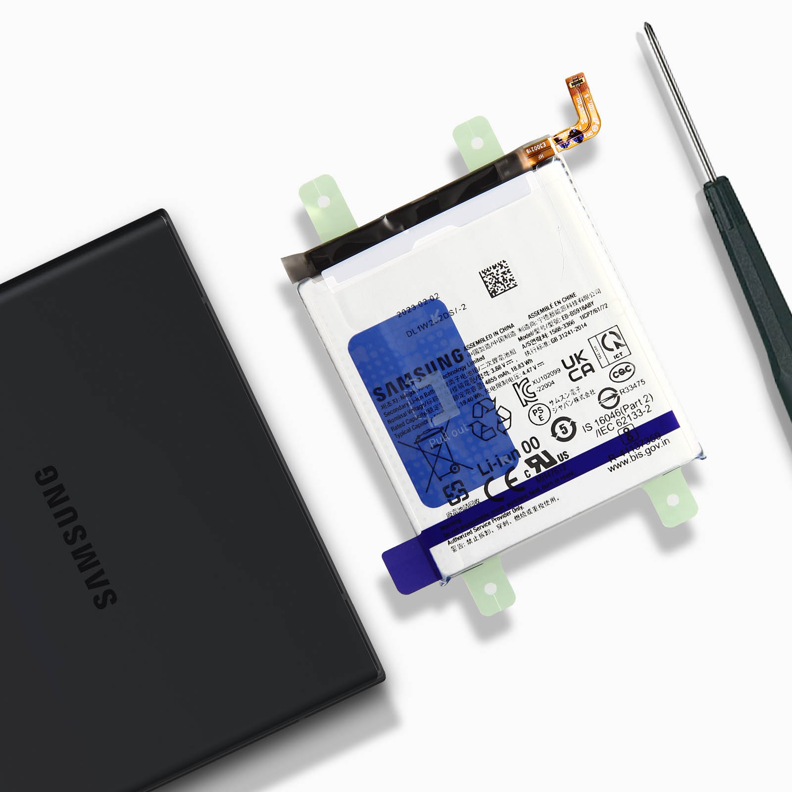 Batteria e telefono nero, con cacciavite. La batteria è bianca con etichetta blu e supporto verde.