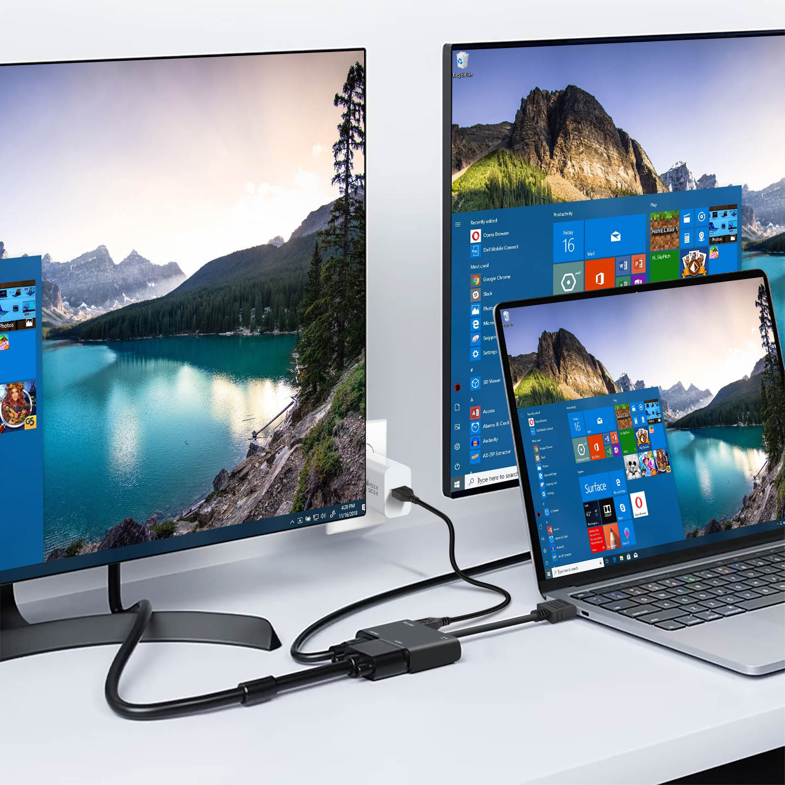Più monitor collegati a un laptop con un hub. Sfondo bianco.