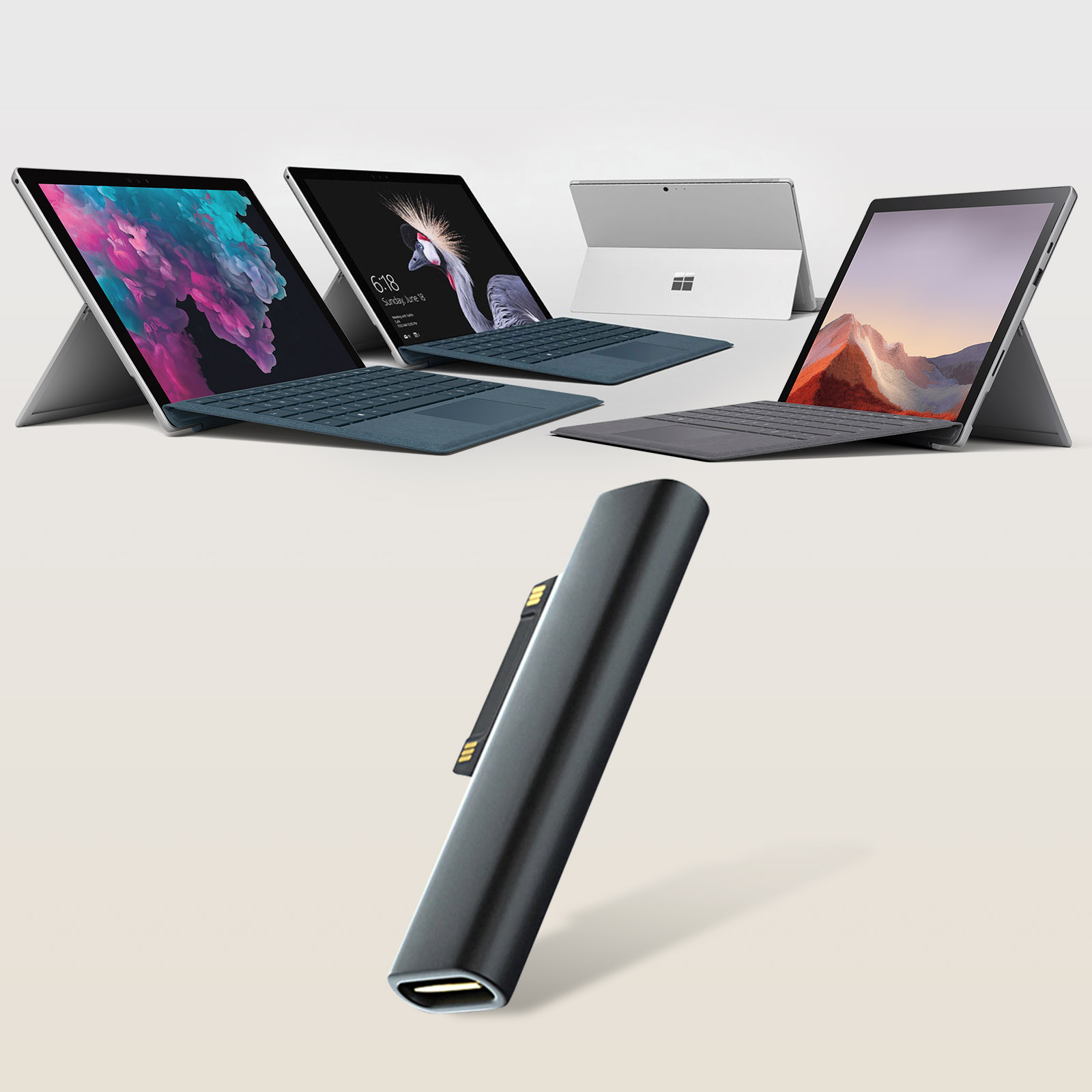 Diversi tablet Microsoft Surface con tastiere e un adattatore USB-C nero.