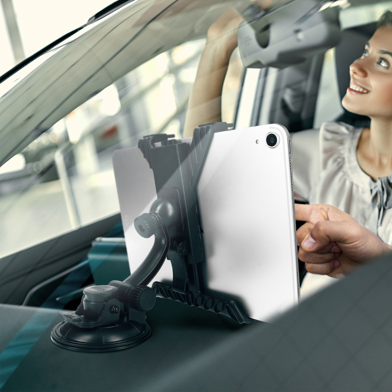 Tablet montato sul cruscotto di un'auto, con una donna sullo sfondo.
