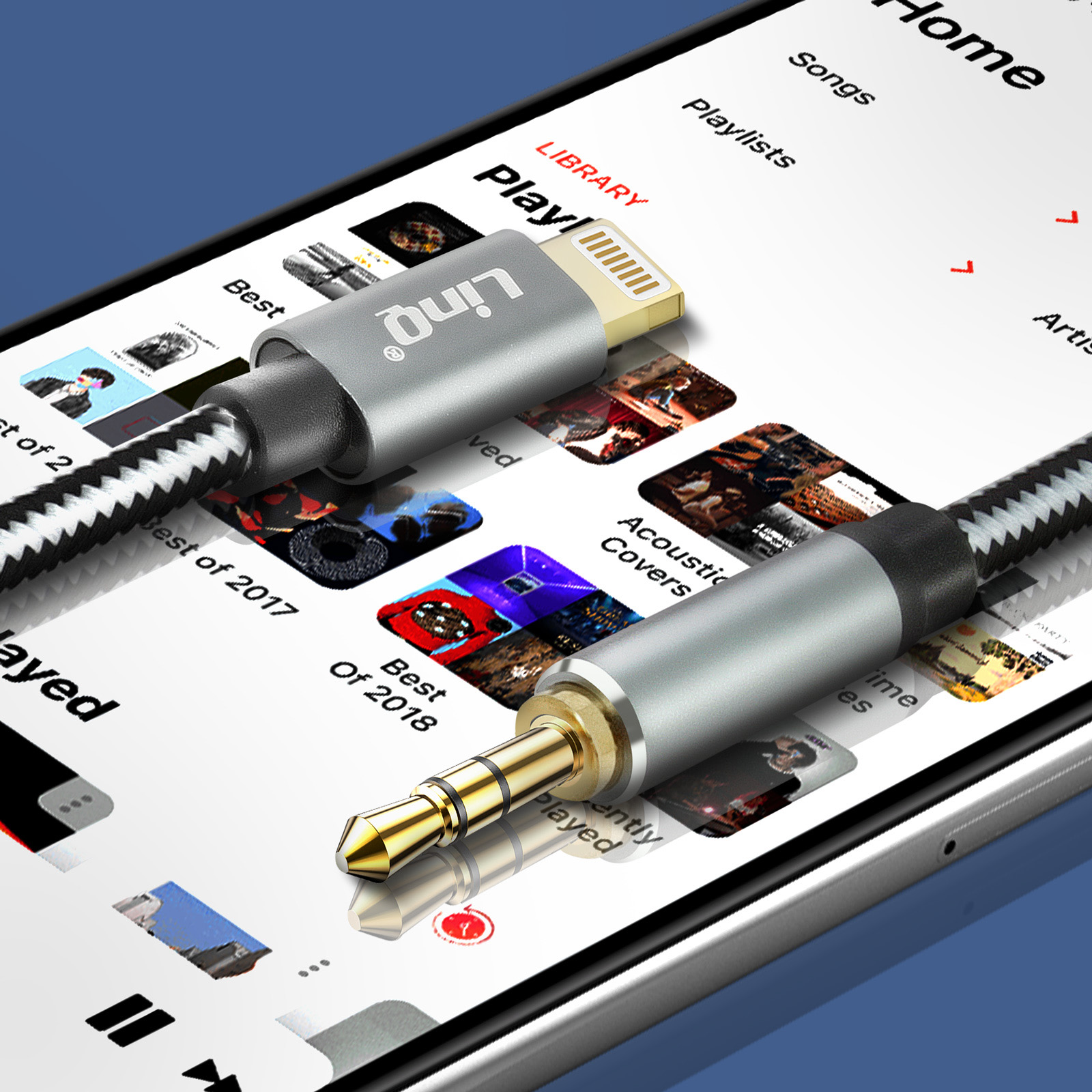 Primer plano de cable de audio conectado a pantalla de teléfono, mostrando app de música con lista de reproducción.