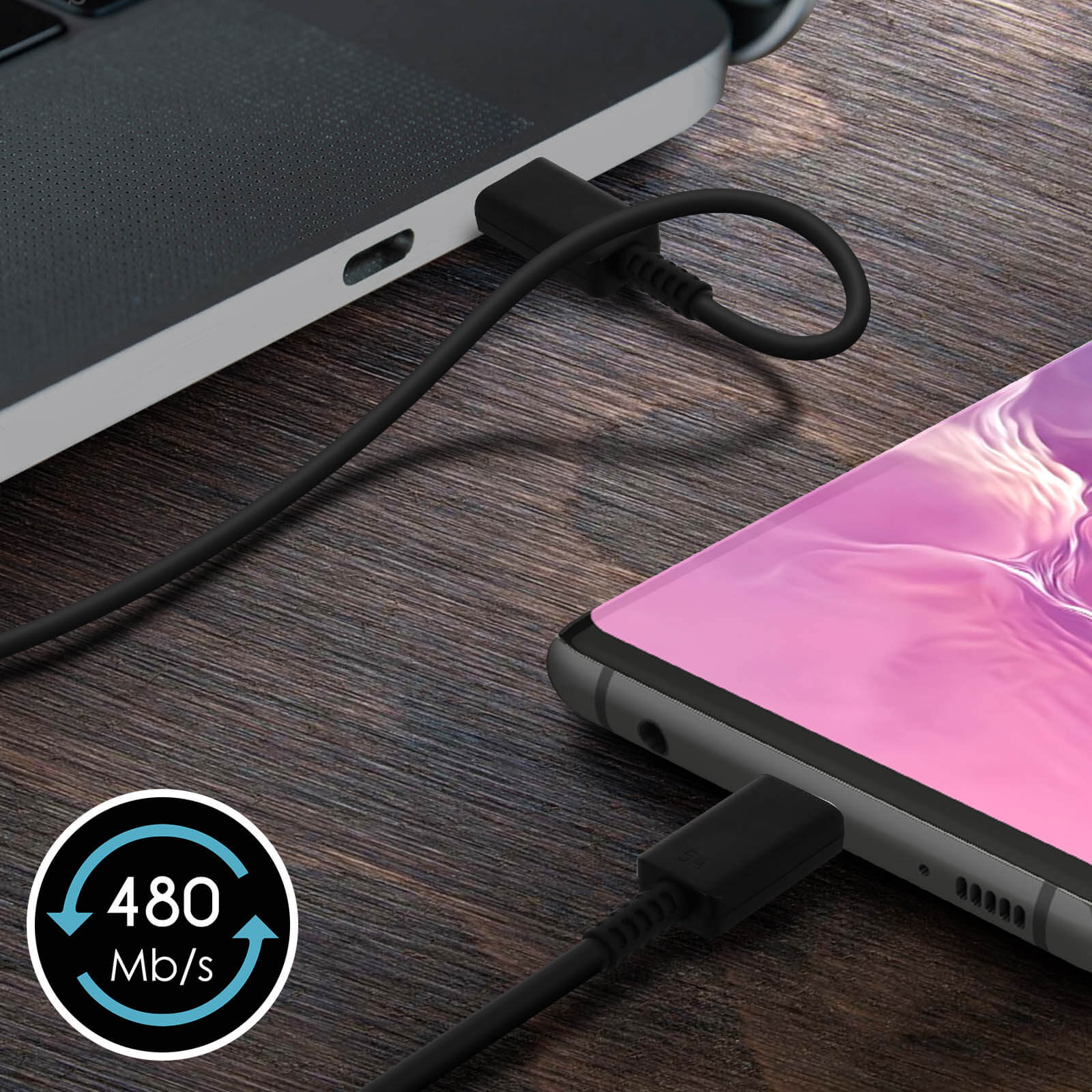 Phone connected to a laptop with a black USB-C cable, with speed indication.