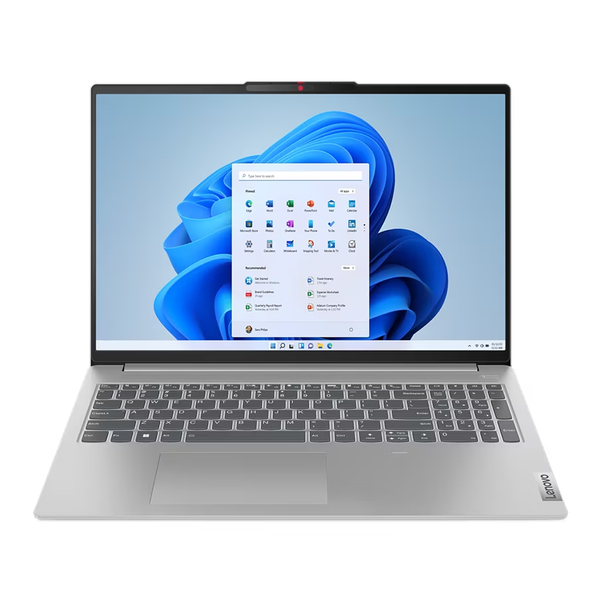 Laptop plateado abierto con interfaz Windows en pantalla, teclado visible y logo Lenovo.