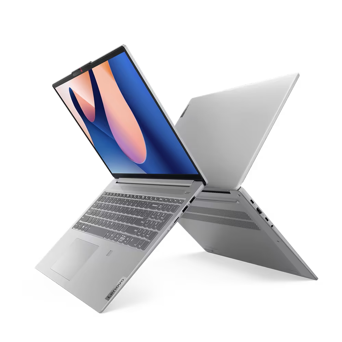 Dos portátiles Lenovo colocados en forma de X sobre una superficie negra. Las pantallas están abiertas.