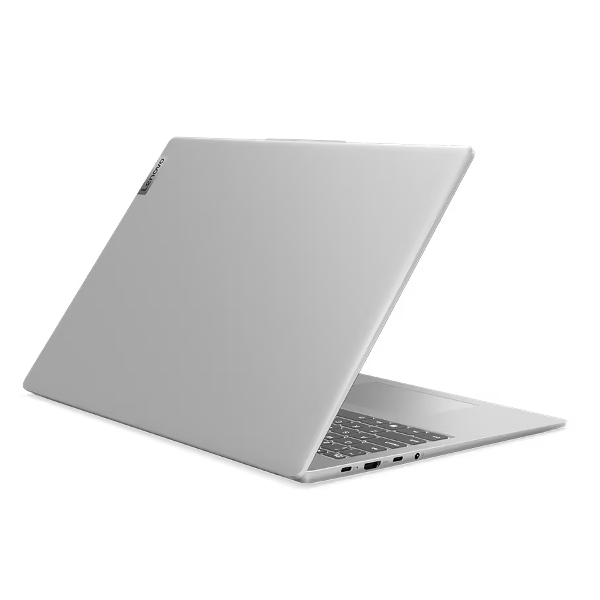 Laptop Lenovo plateado, abierto en ángulo. Fondo negro.