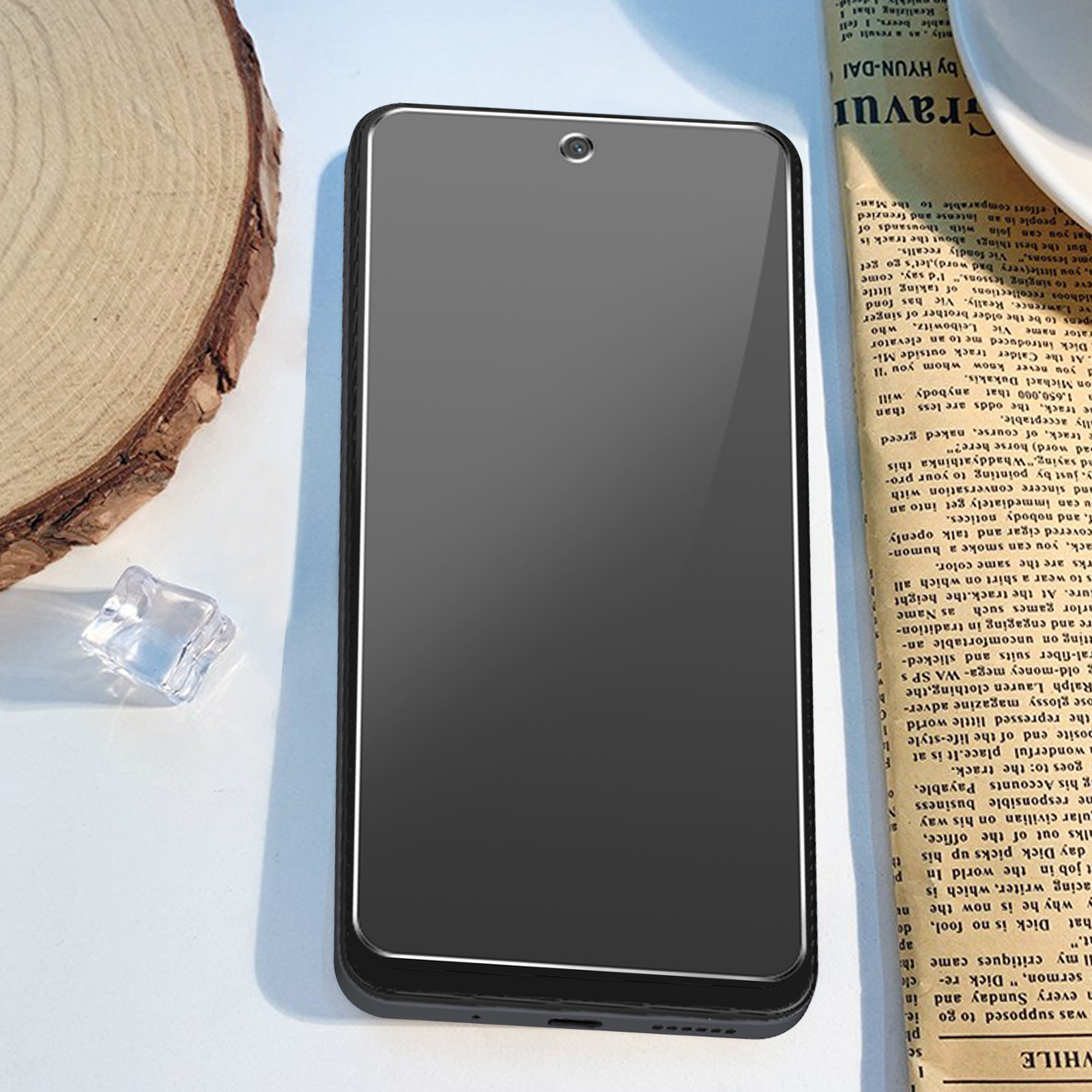 Smartphone nero su legno, sfondo sfocato con testo di giornale.