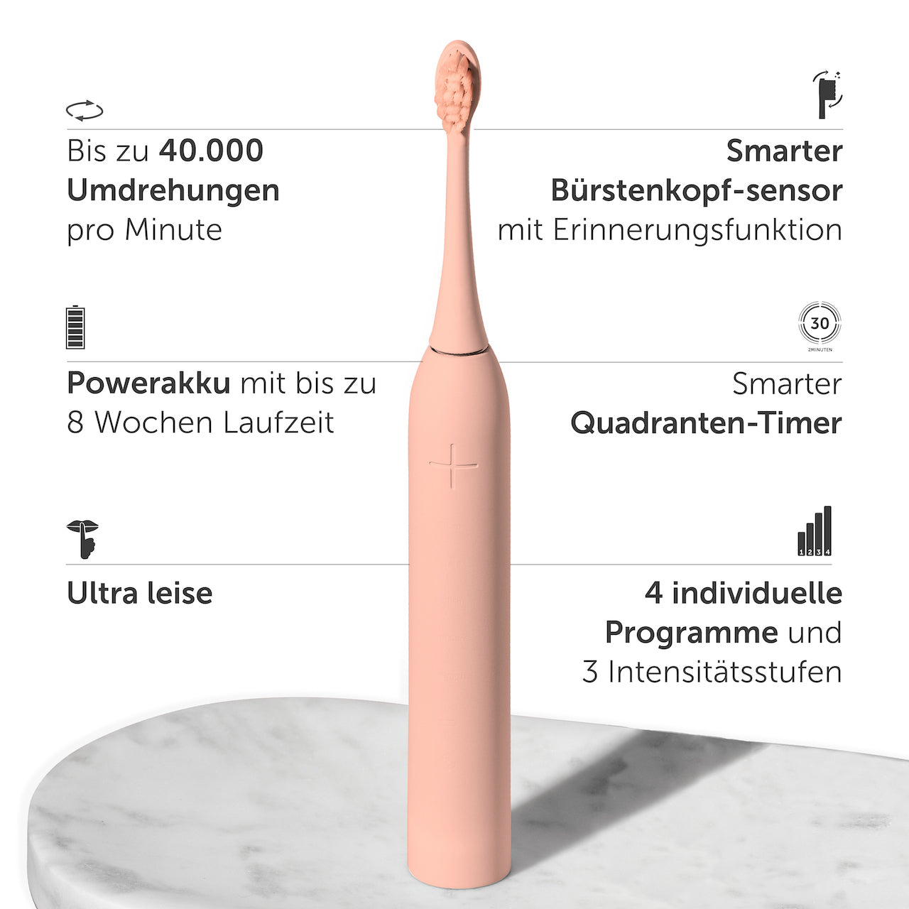 Eine rosa elektrische Zahnbürste mit Textbeschreibungen ihrer Eigenschaften auf Marmor.