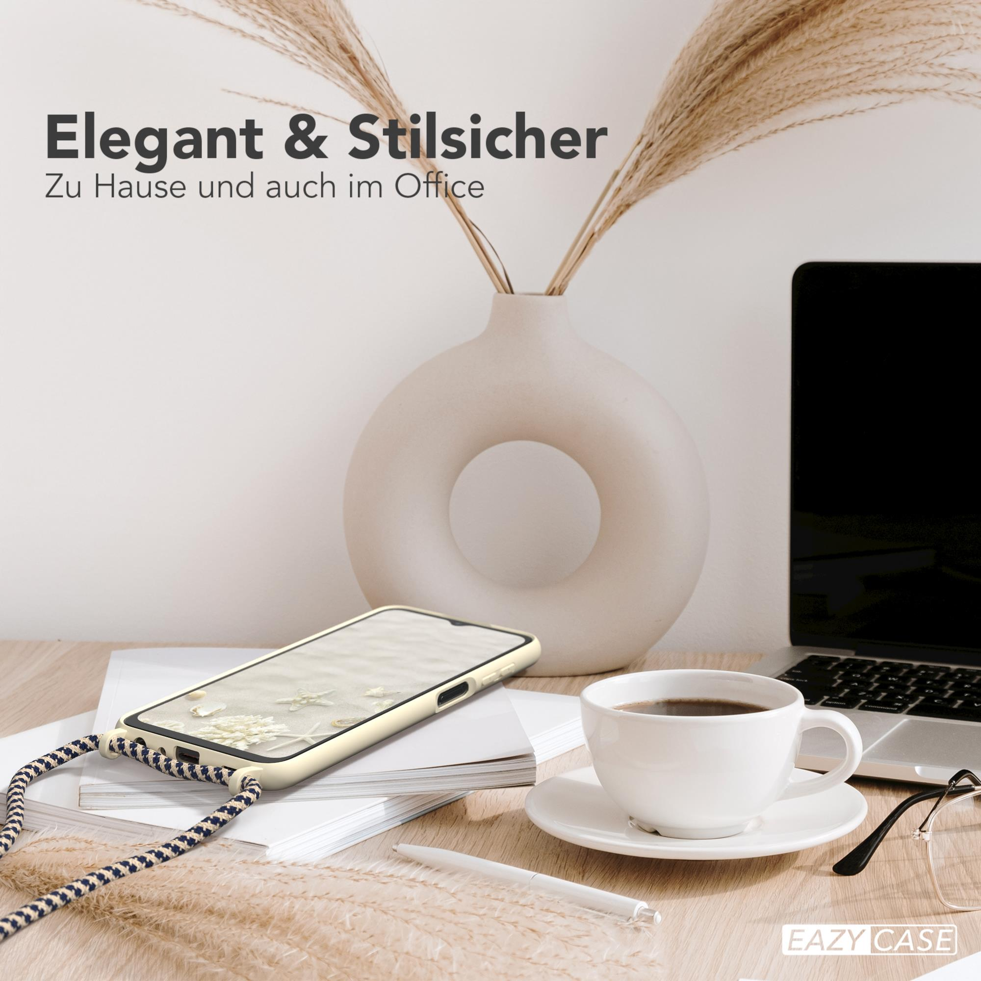 Ein Telefon mit Seilriemen auf einem Schreibtisch mit Laptop, Kaffeetasse und Vase mit Pflanzen.