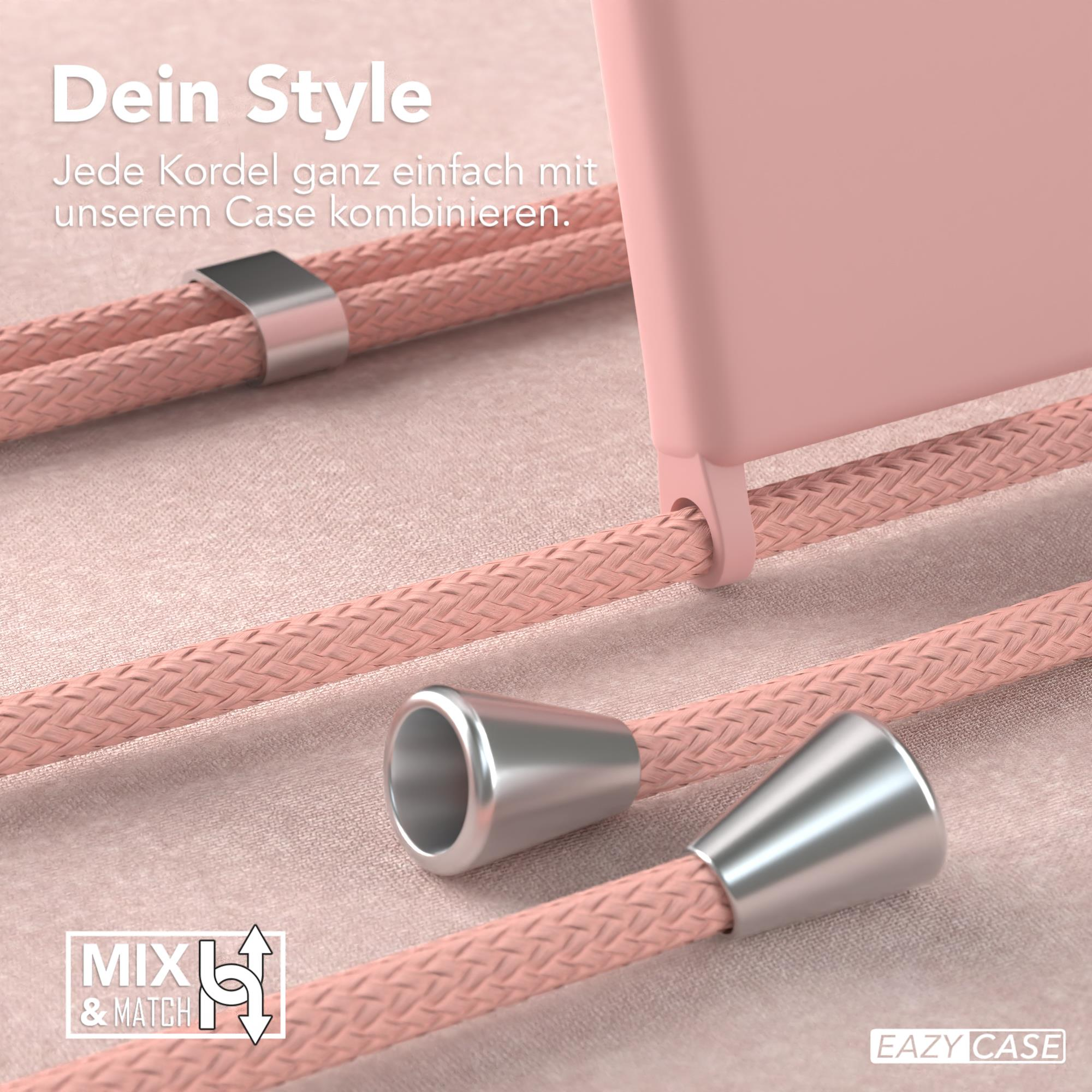Nahaufnahme einer rosa Handyhülle mit rosafarbenem Kordel. Silberne Metalldetails. Weißer Hintergrund.