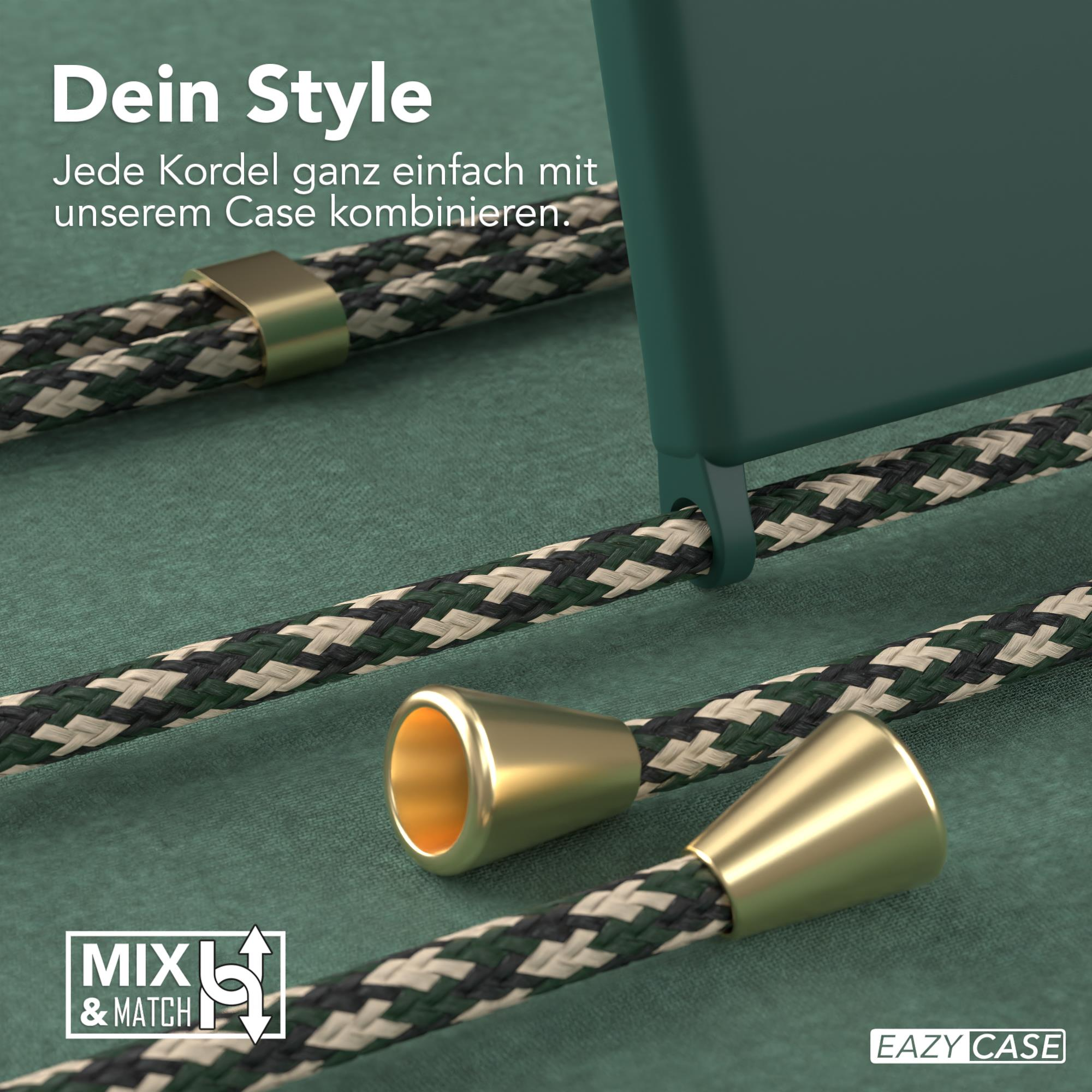 Nahaufnahme eines Handyhüllen mit einem Riemen, goldfarbenen Metallteilen an grün-schwarzem Kabel, auf grüner Oberfläche.