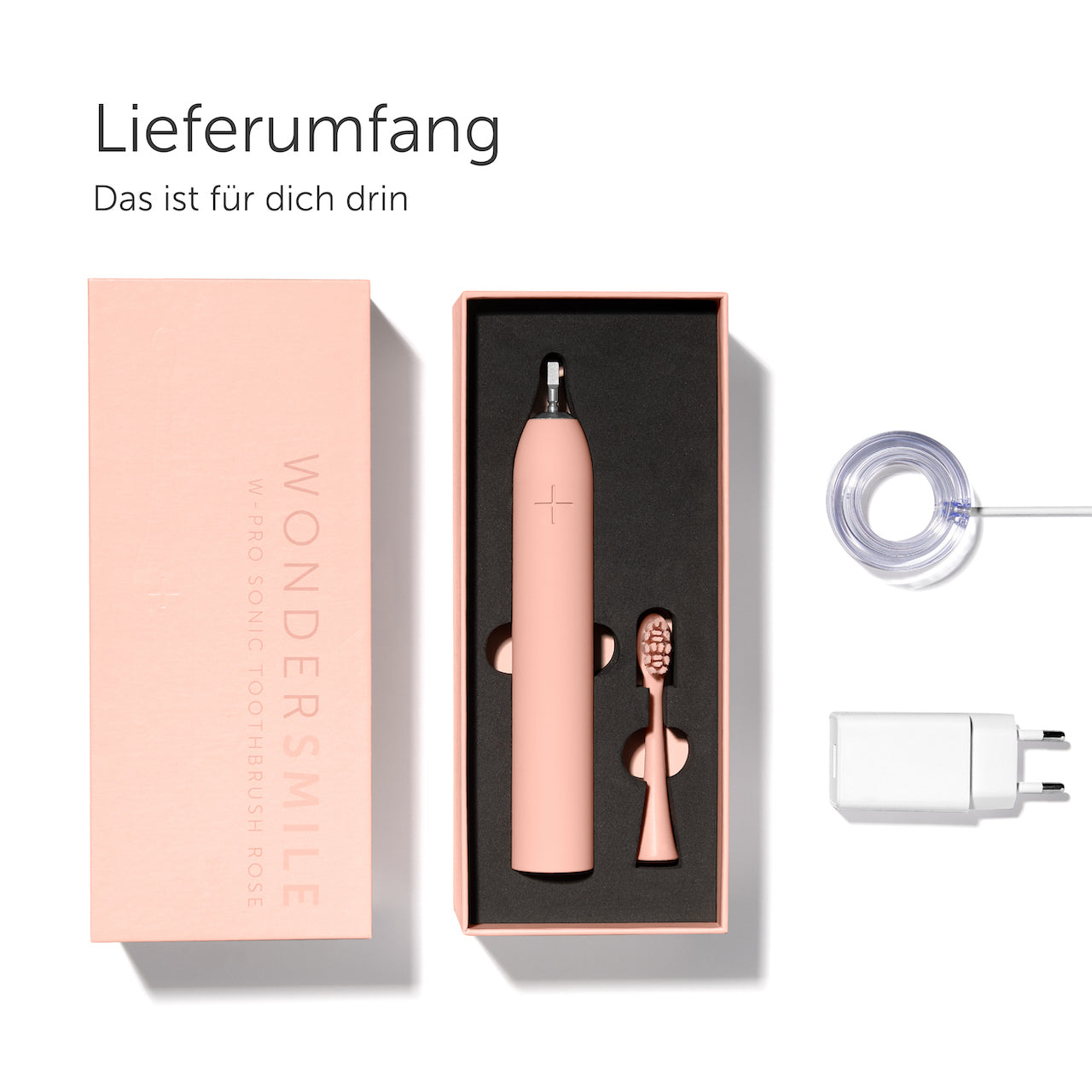 Rosa Zahnbürsten-Set mit Bürste, zusätzlichem Kopf, Ladegerät und einer Box.