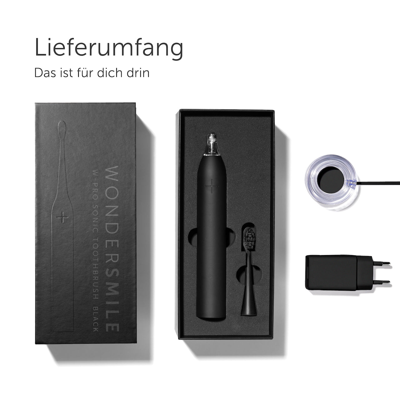 Schwarzes Zahnbürstenset: Zahnbürste, Ladegerät und Ladestation in einer Box. Weißer Hintergrund.