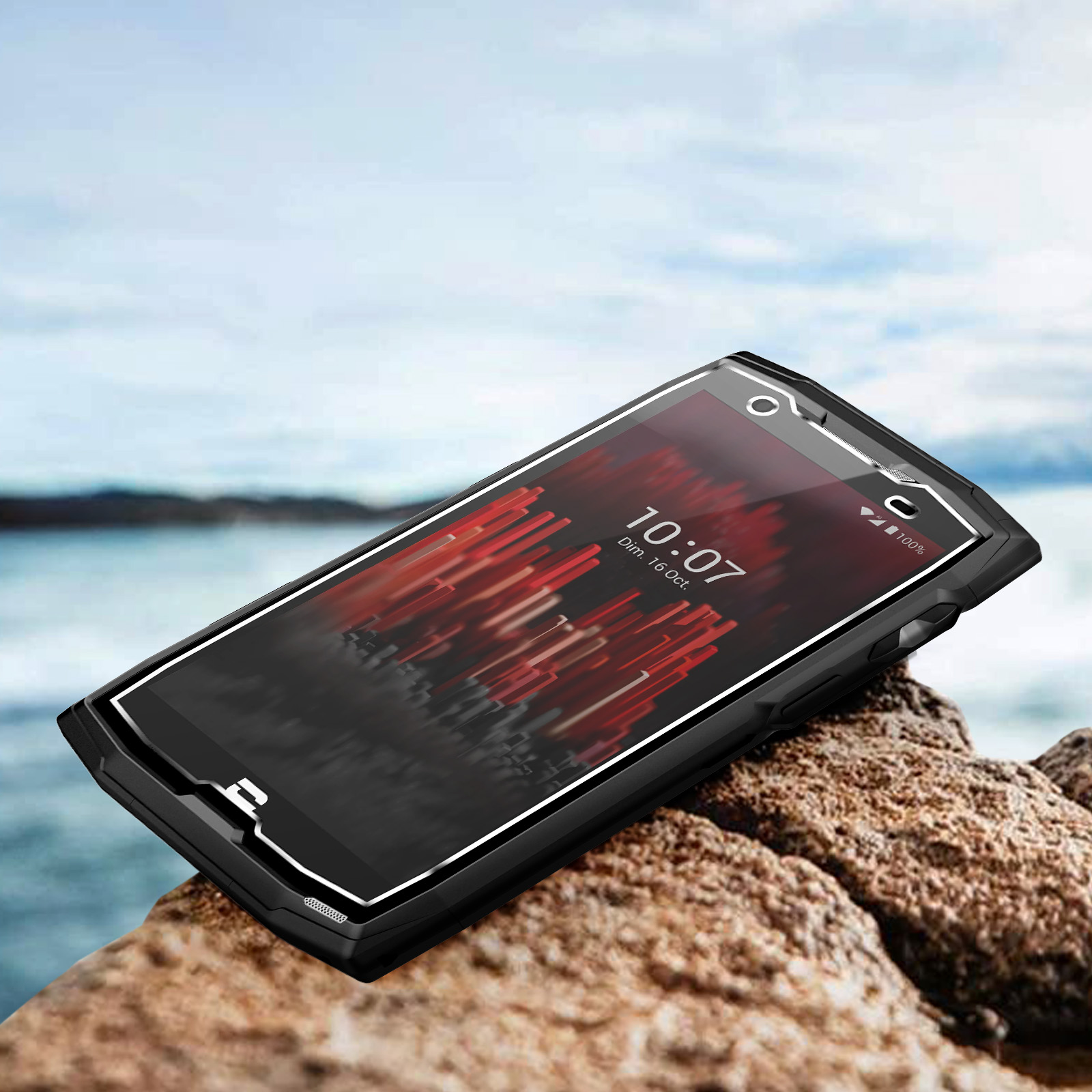 Telefono nero, con schermo visibile con visualizzazione dell'ora, sulle rocce.