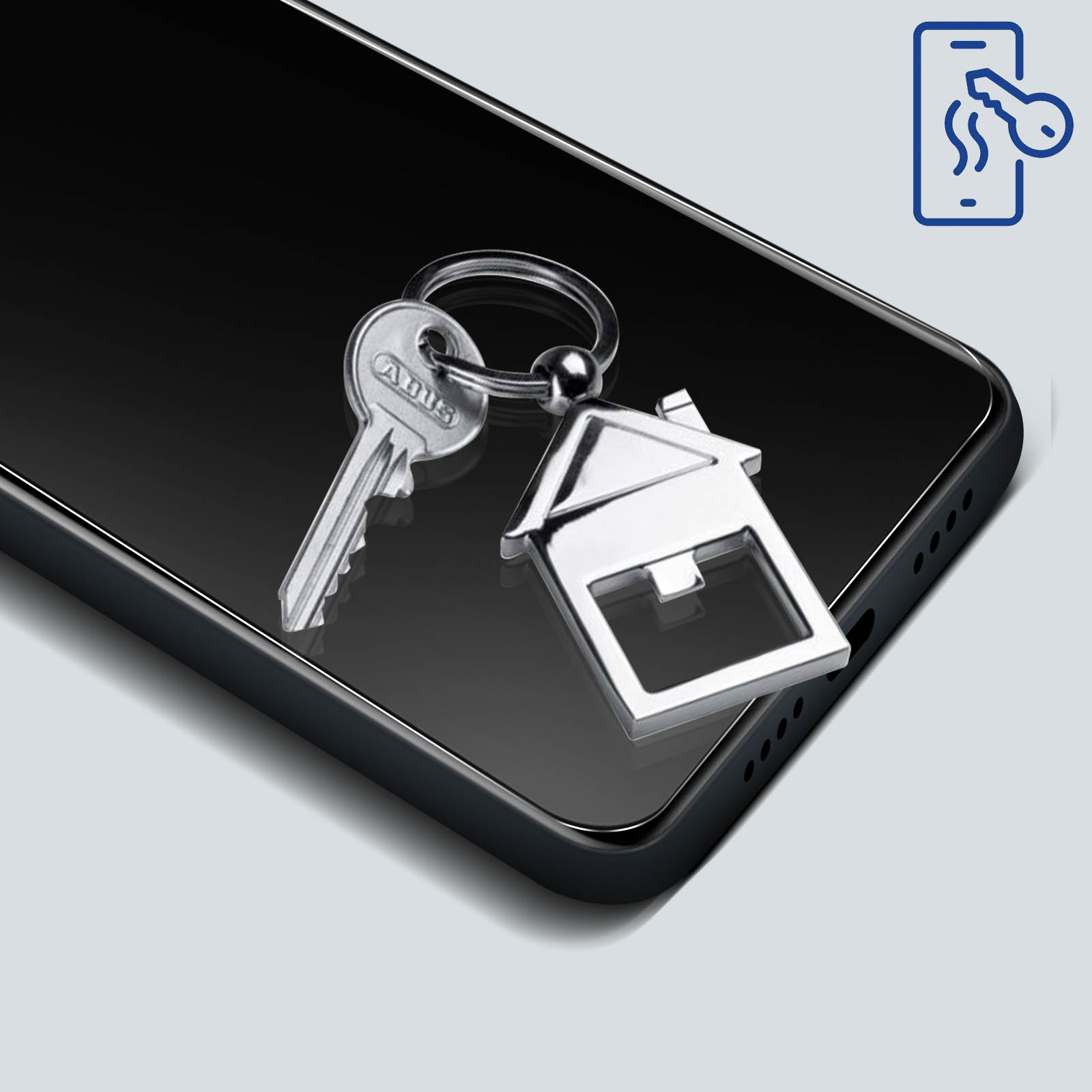 Telefon z kluczami i brelokiem w kształcie domu. Ikona klucza jest pokazana w prawym górnym rogu.