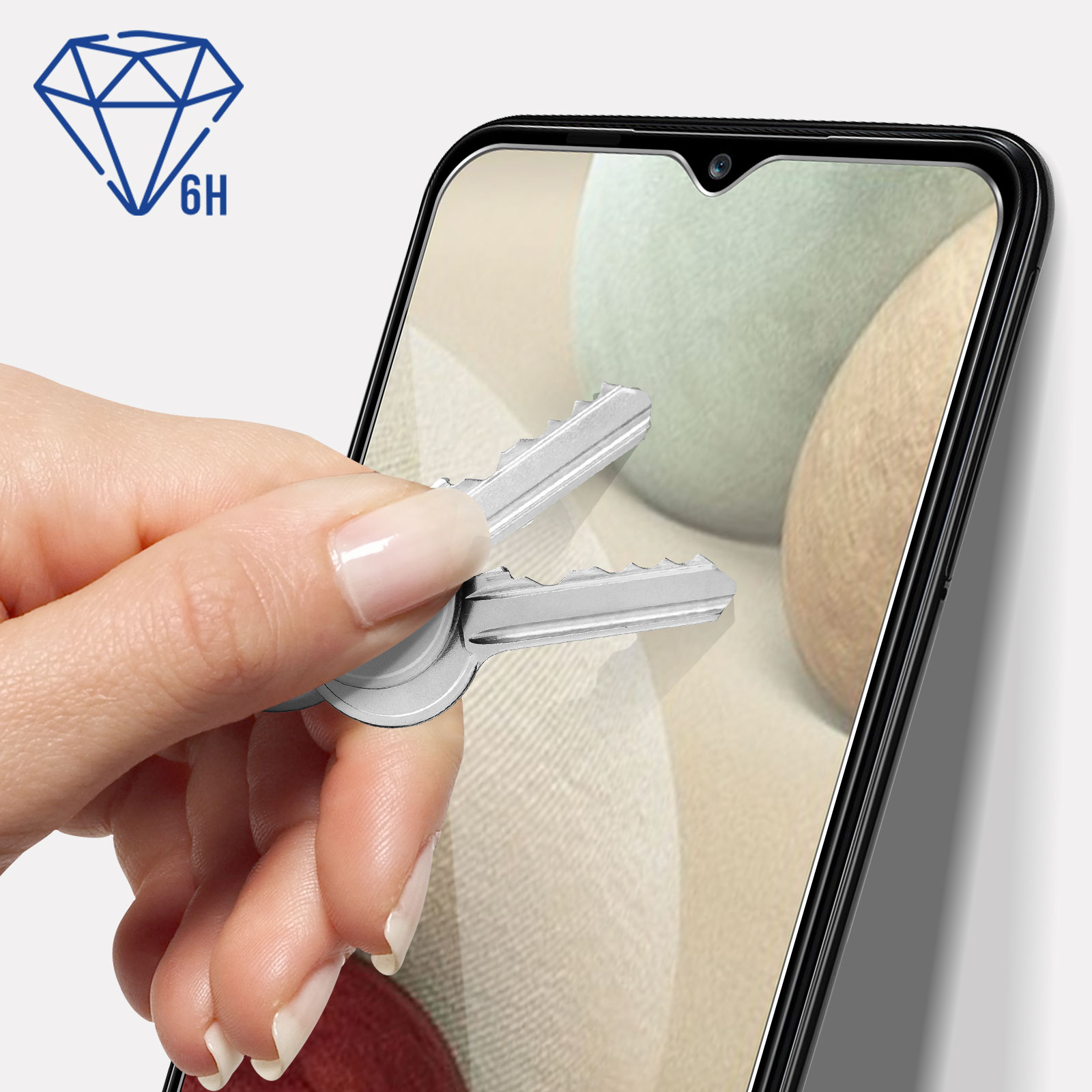 Ręka trzyma klucze w pobliżu telefonu z ochroną ekranu. Ochraniacz ekranu ma ikonę diamentu.