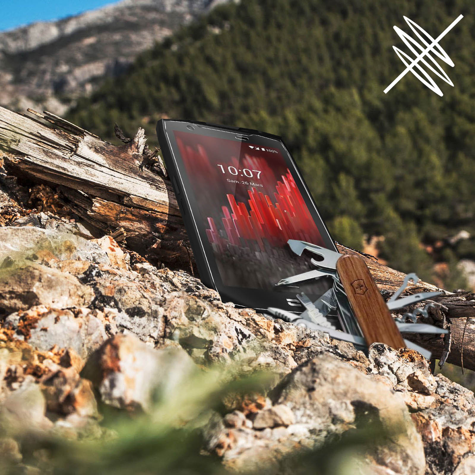 Un smartphone avec une interface rouge est sur un rocher avec un couteau multi-outils.