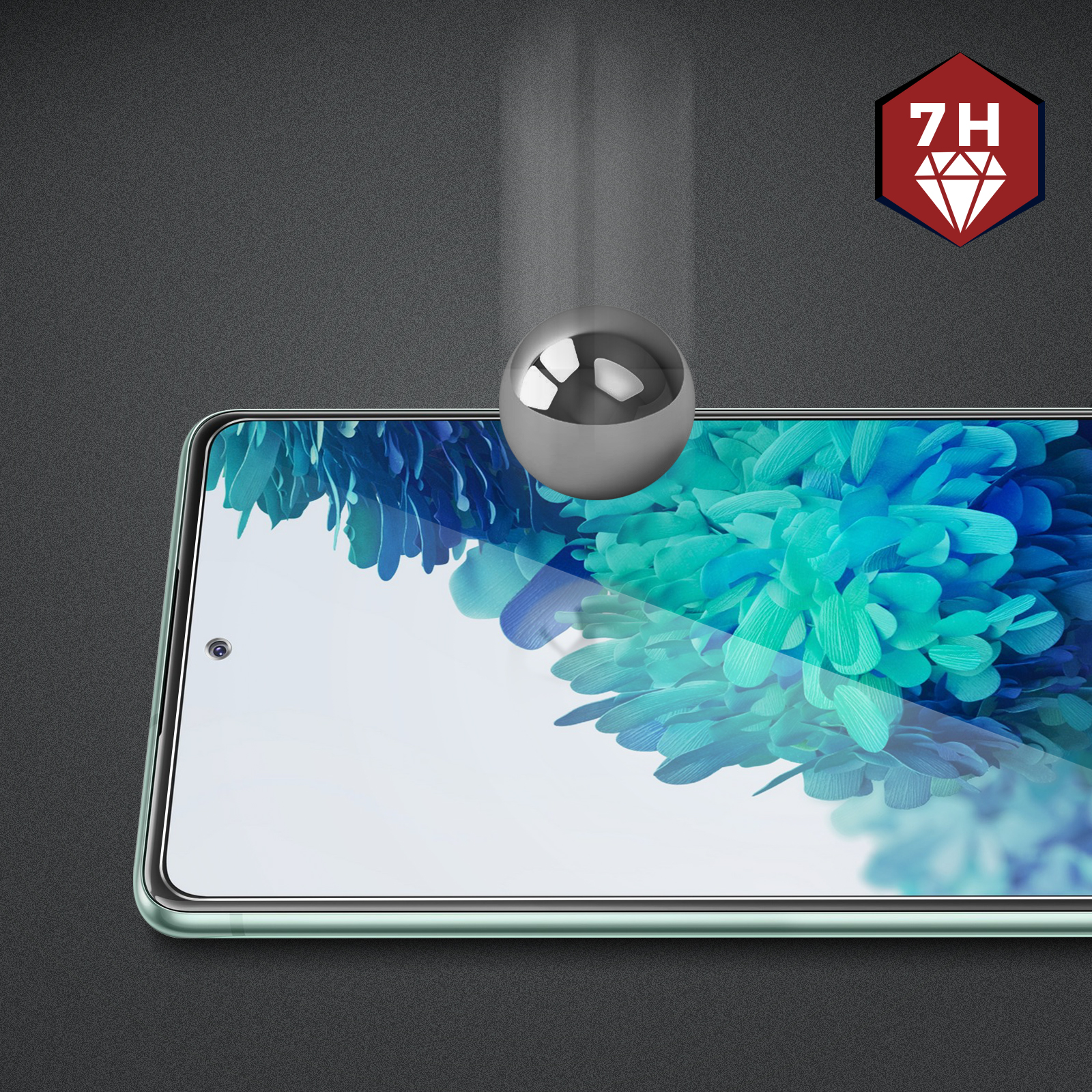 Srebrna kulka uderzająca w ekran telefonu. Telefon ma osłonę ekranu. Tło jest szare.