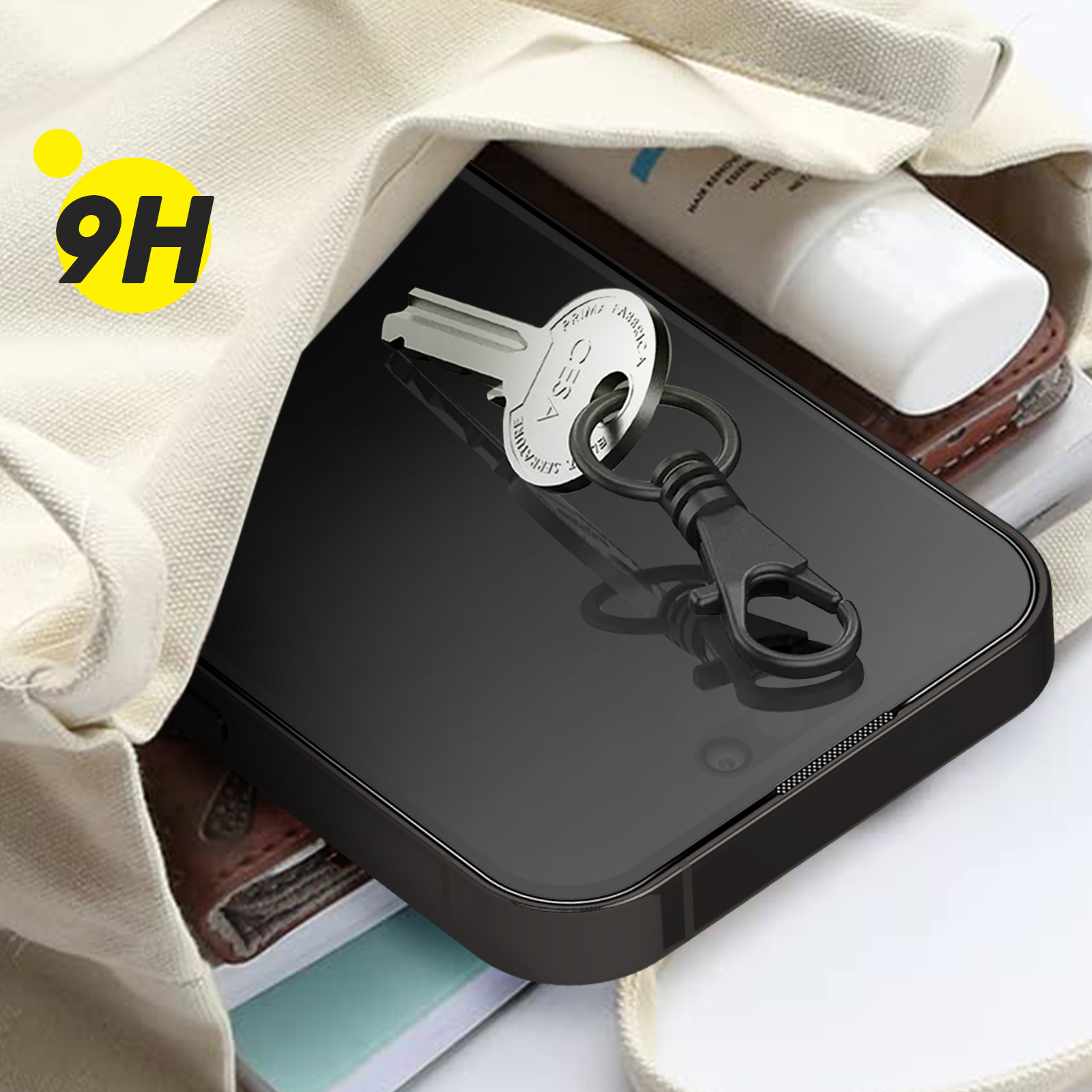Phone screen with key and bag. The key is on a keychain. The bag is beige.